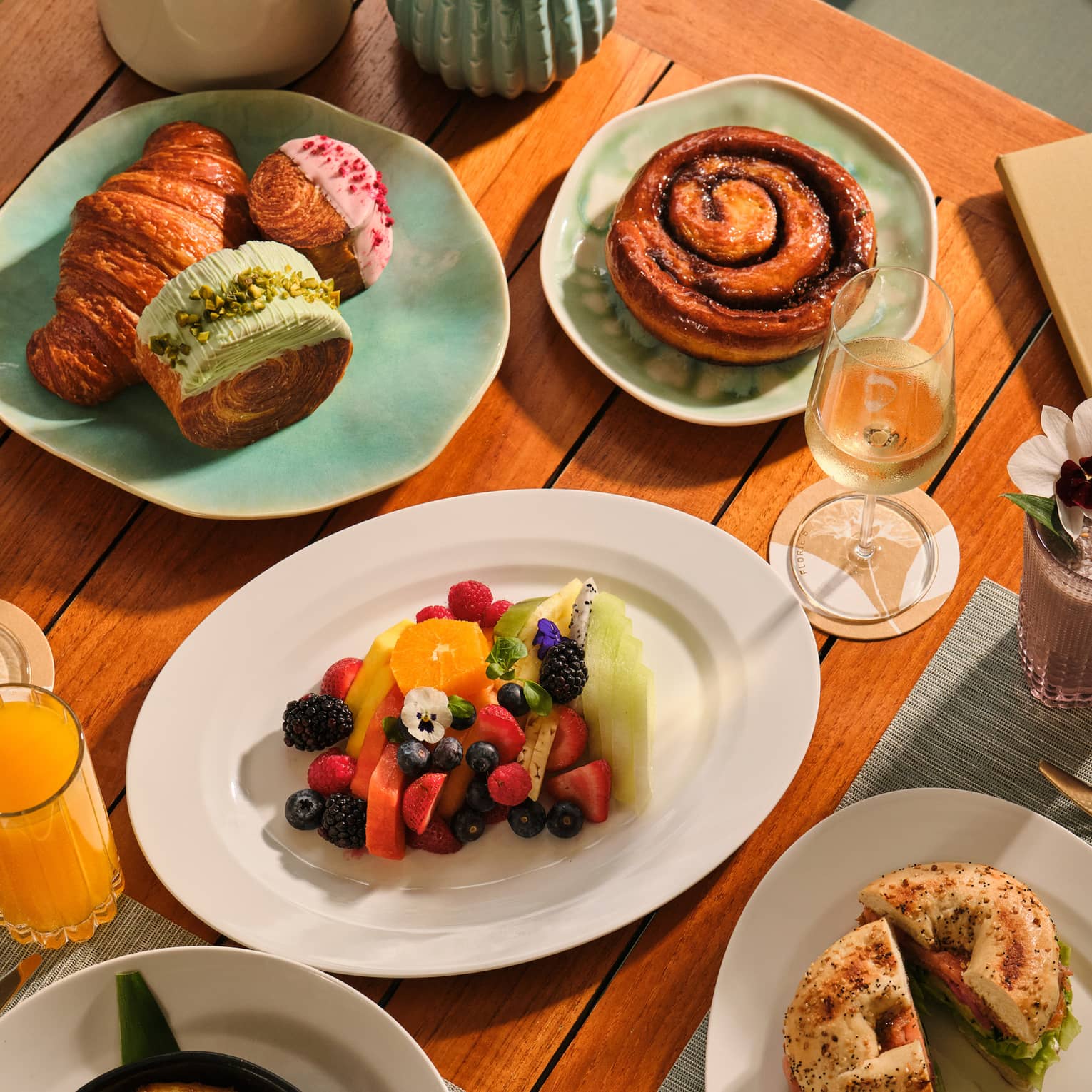 Outdoor table filled with a variety of breakfast dishes