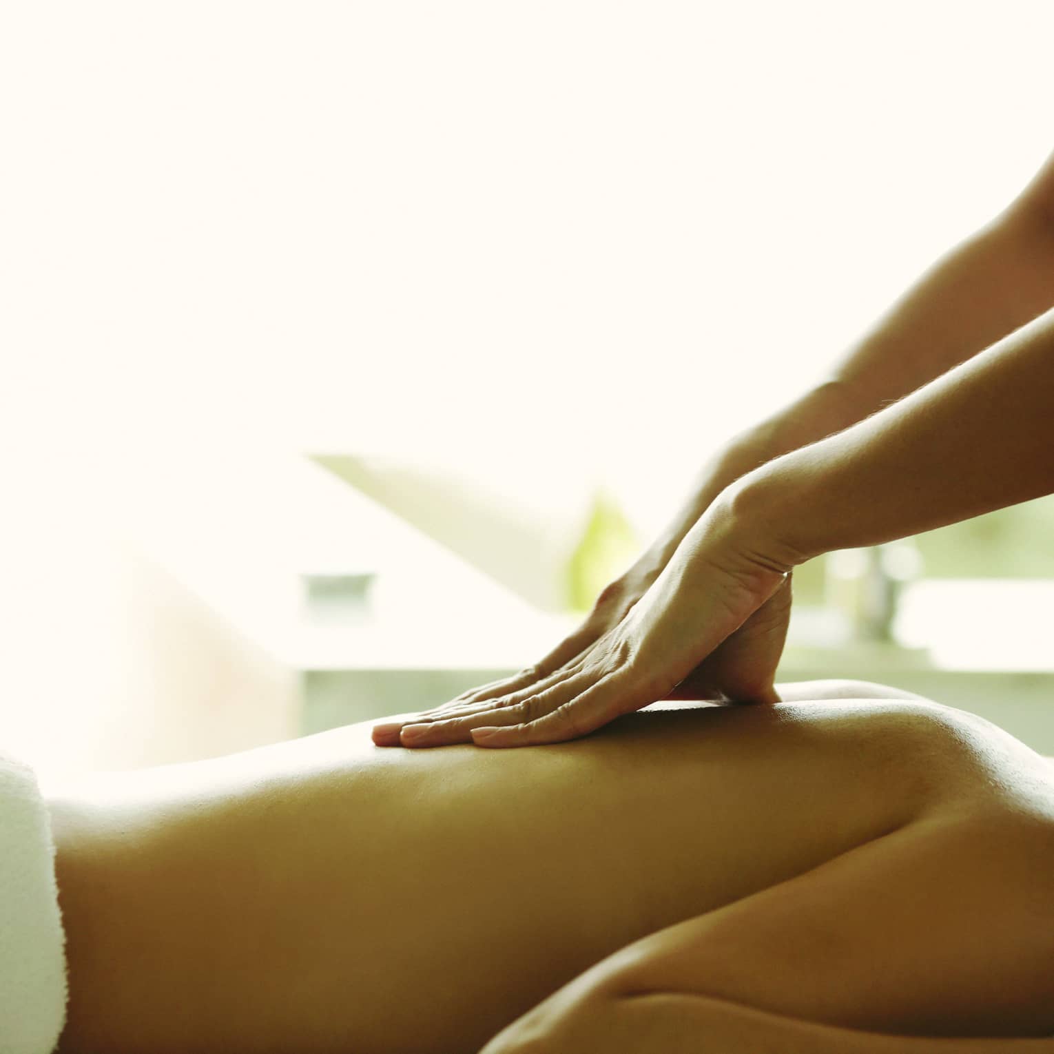 Close-up of a person receiving a relaxing back massage in a spa setting.