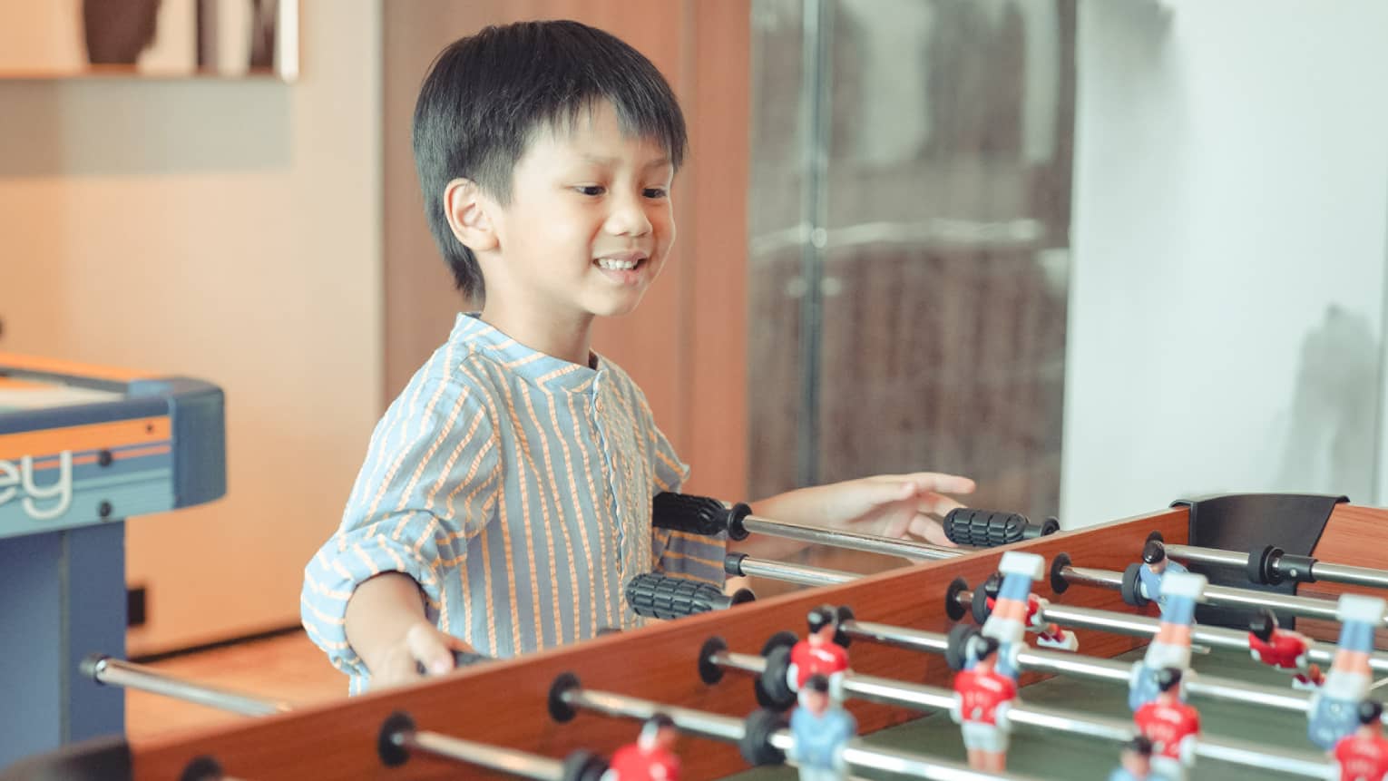 Young boy plays foosball