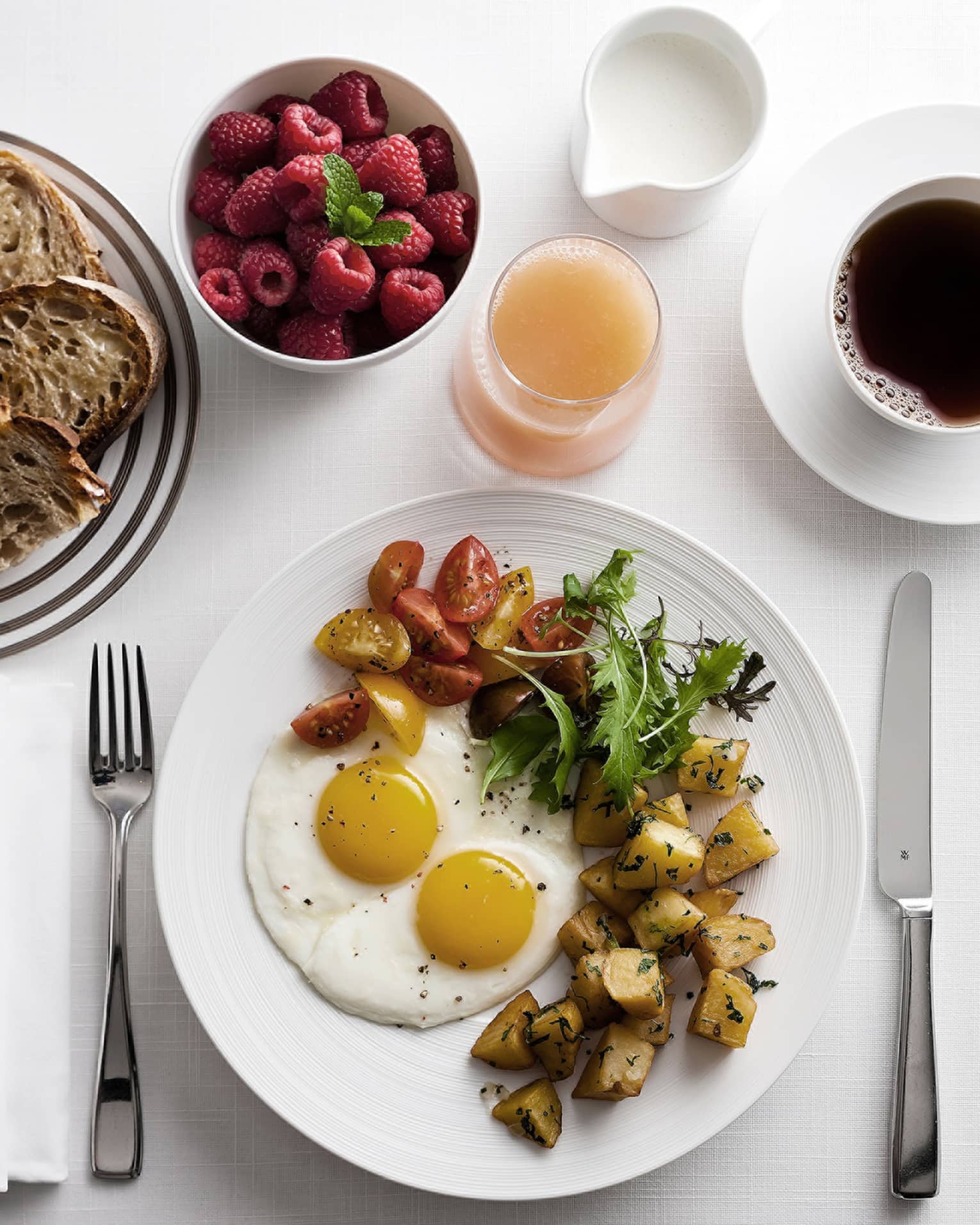 In-bungalow dining breakfast with sunny side egg, roast potatoes and salad, toast, coffee and fresh fruit