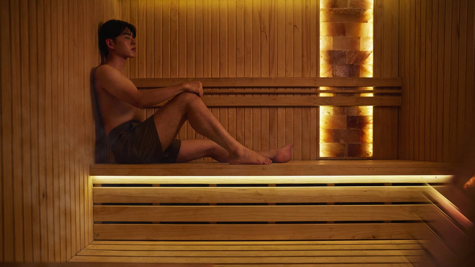 A man lounges in a sauna