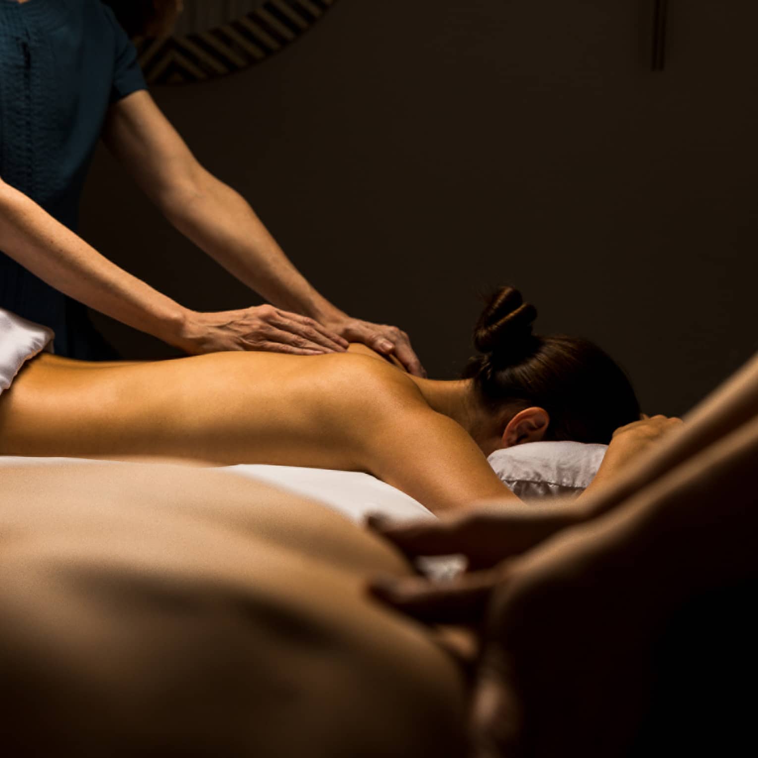 Two guests lay side by side for massage treatments