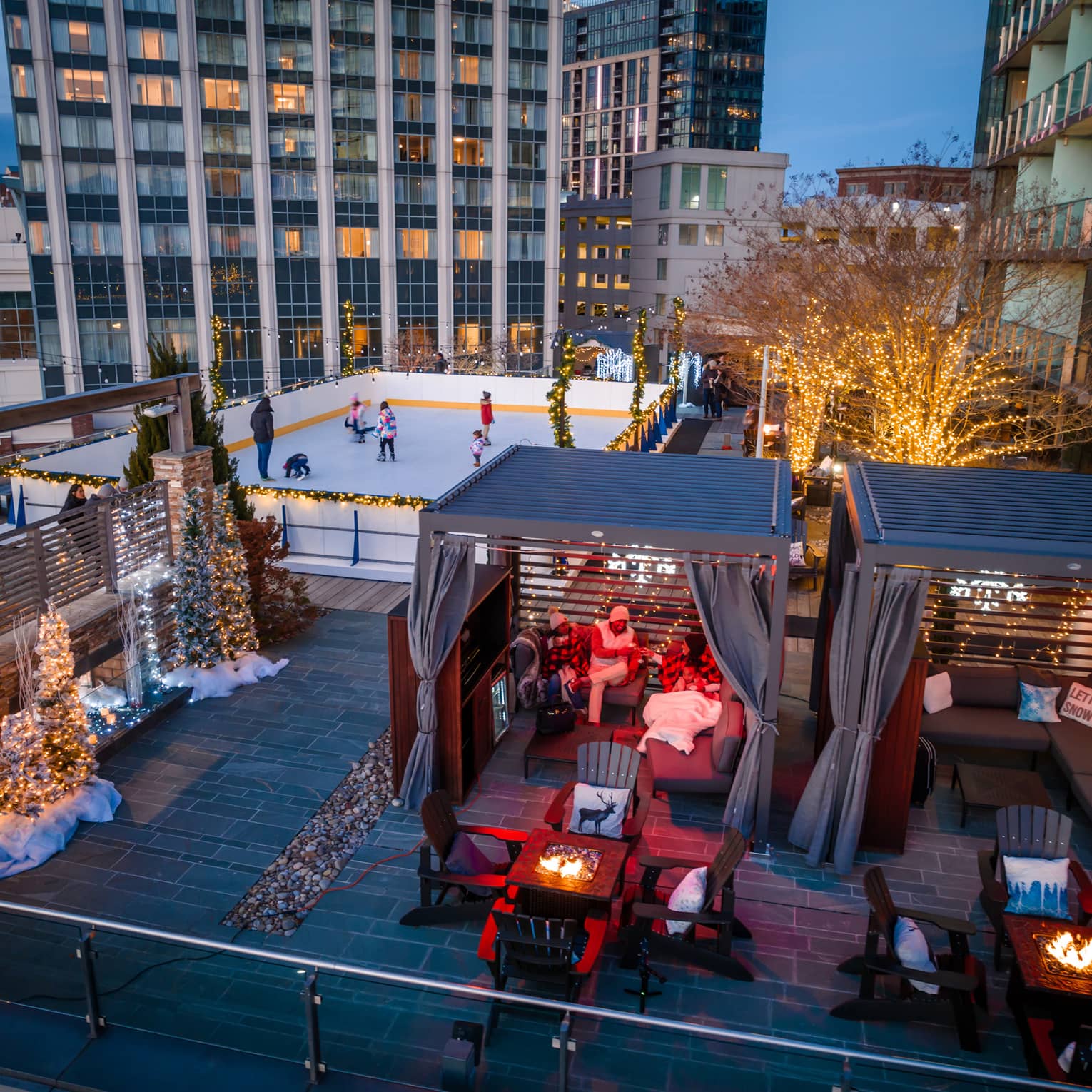 A rooftop with ice skating, and chalets.