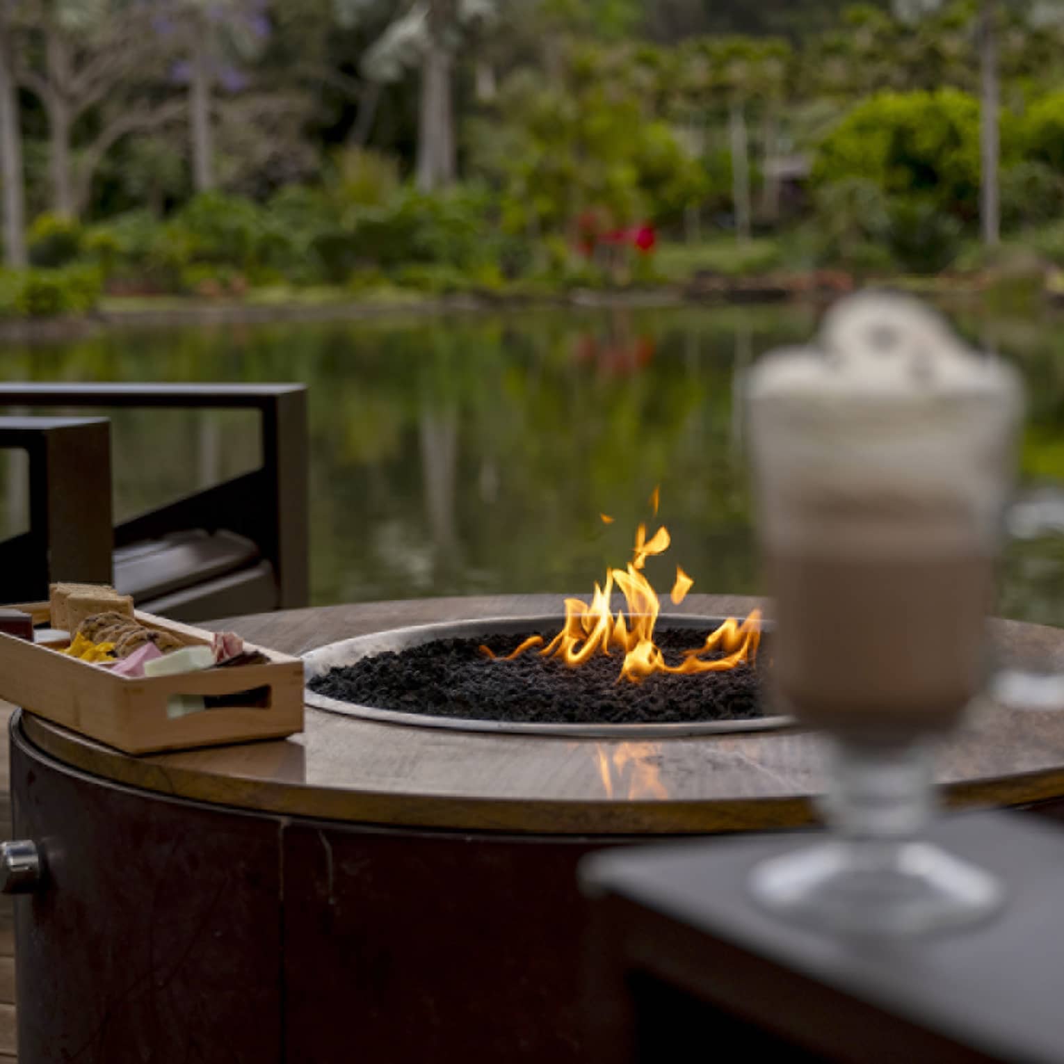 Outdoor, lakeside s'mores and hot chocolate on a deck