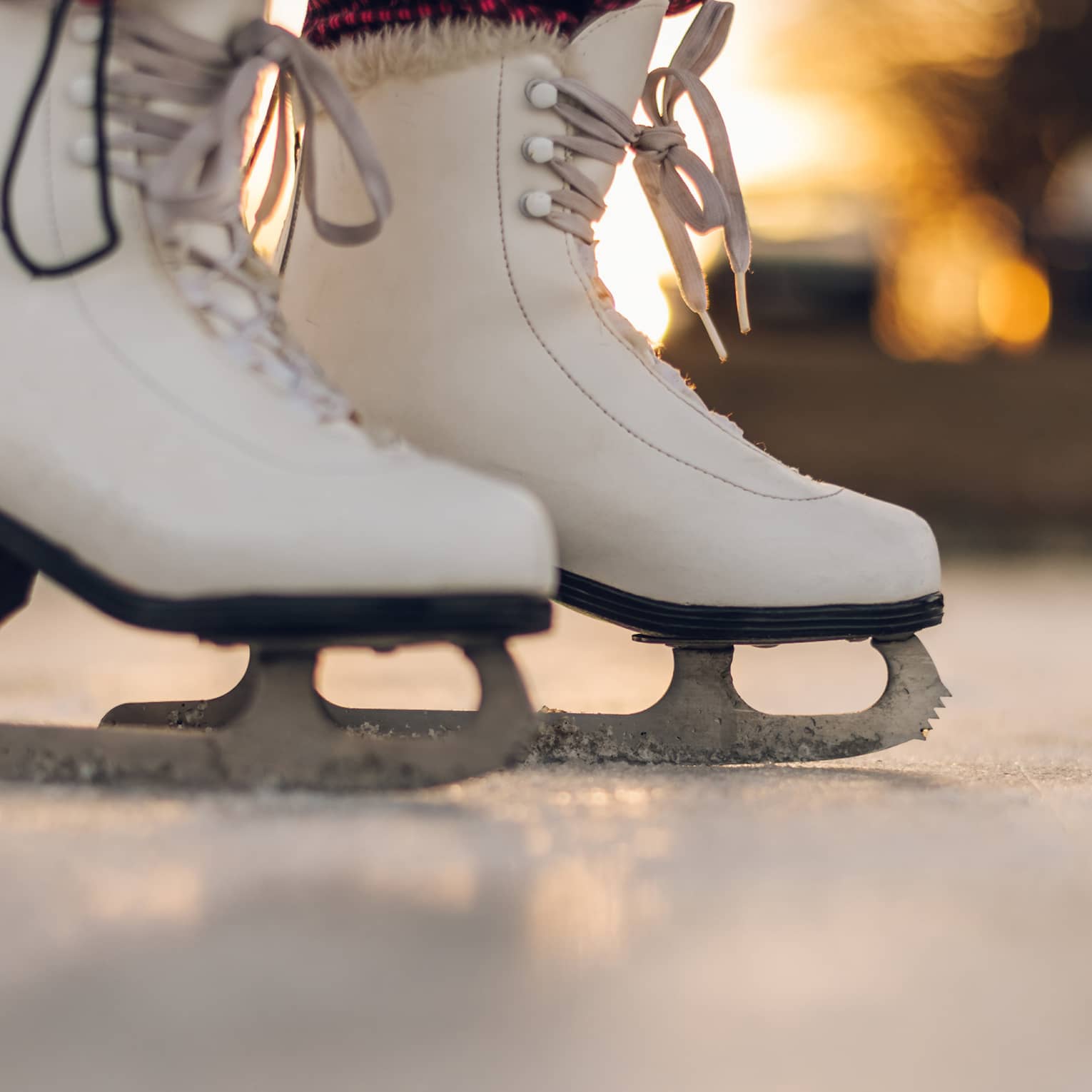 A pair of white ice skating boots.