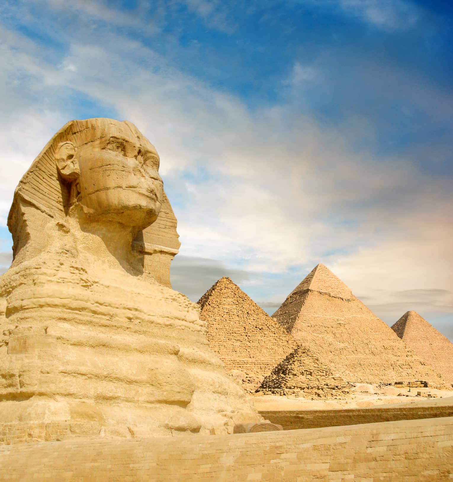 Famouse Sphinx and the great pyramids under interesting evening clouds, Cairo, Egypt