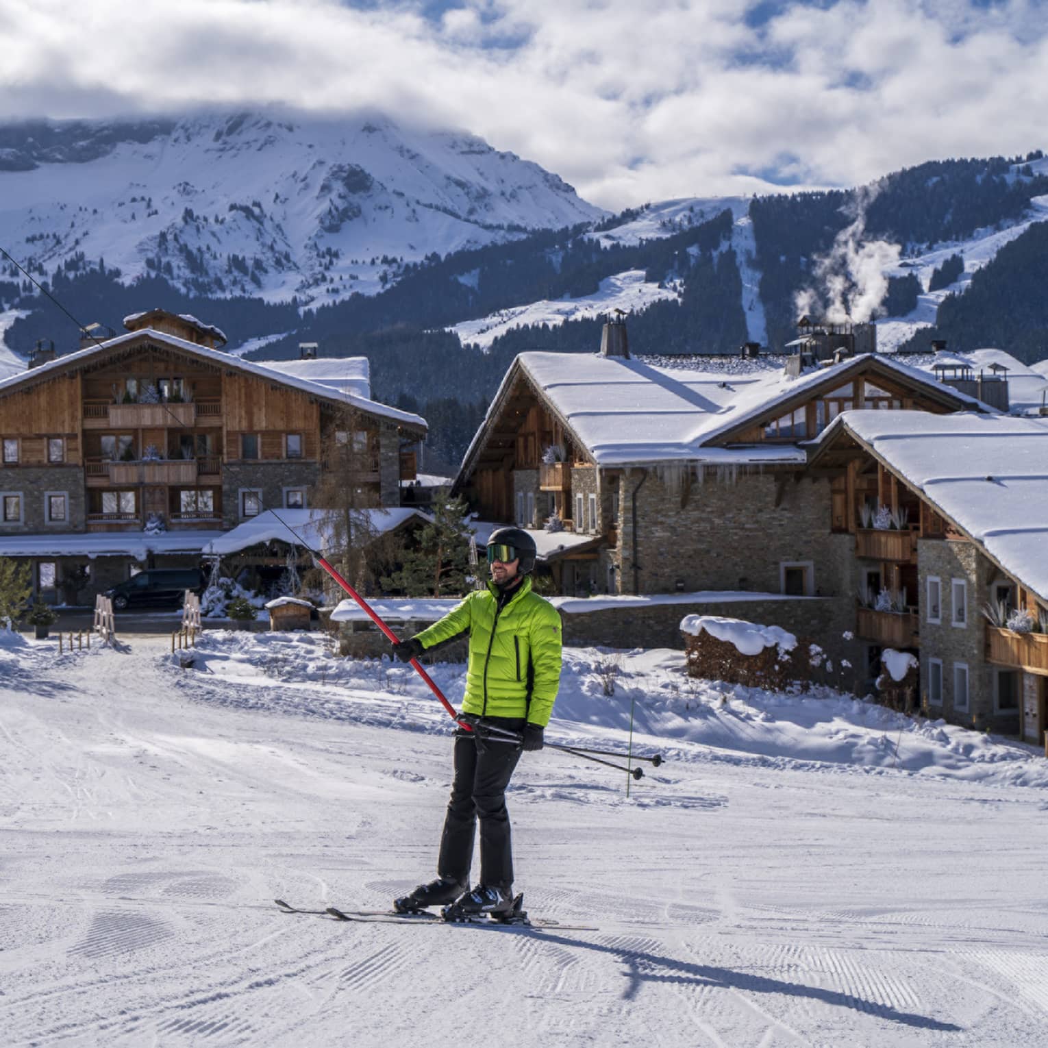 A person in a bright green ski jacket on snow.