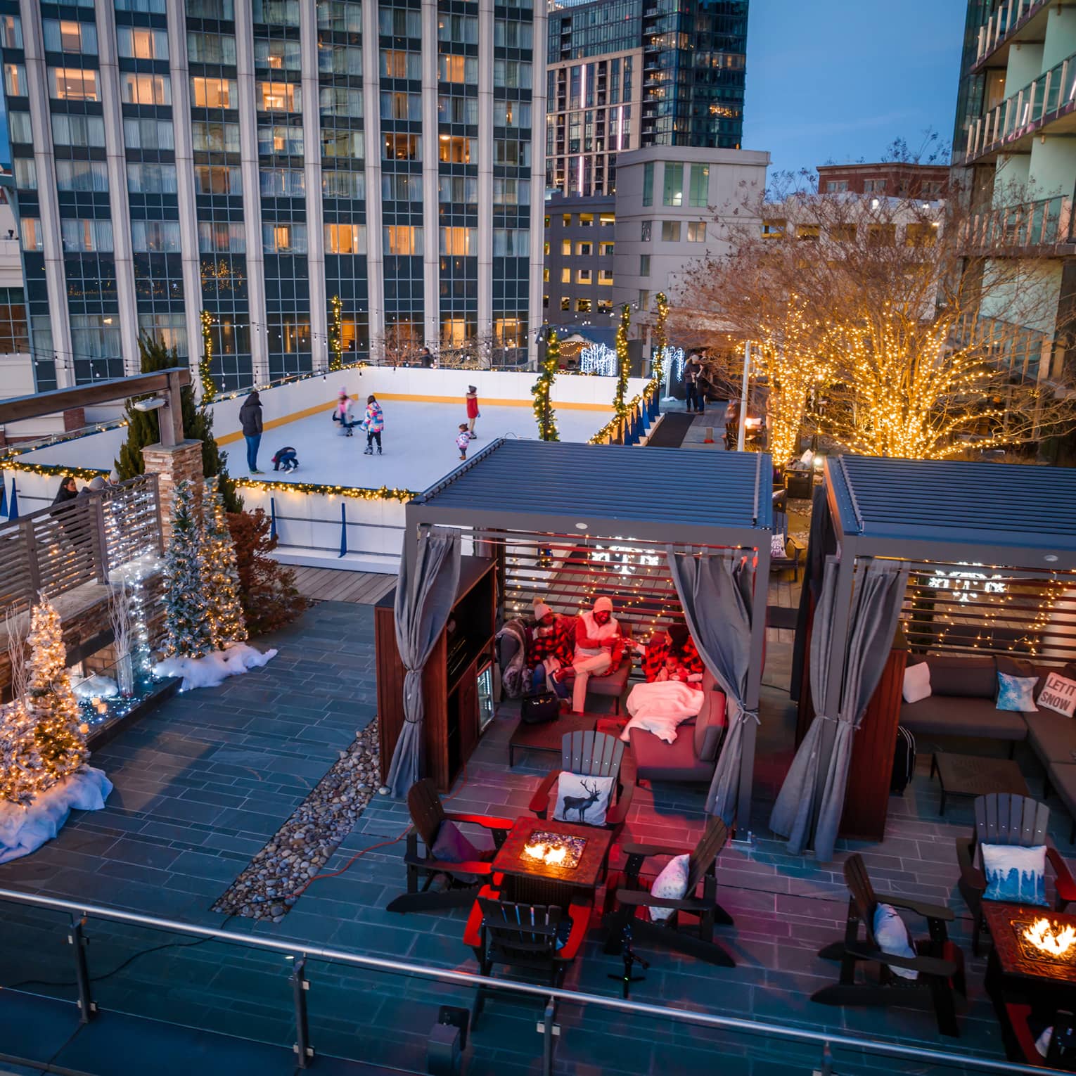 A rooftop with ice skating, and chalets.