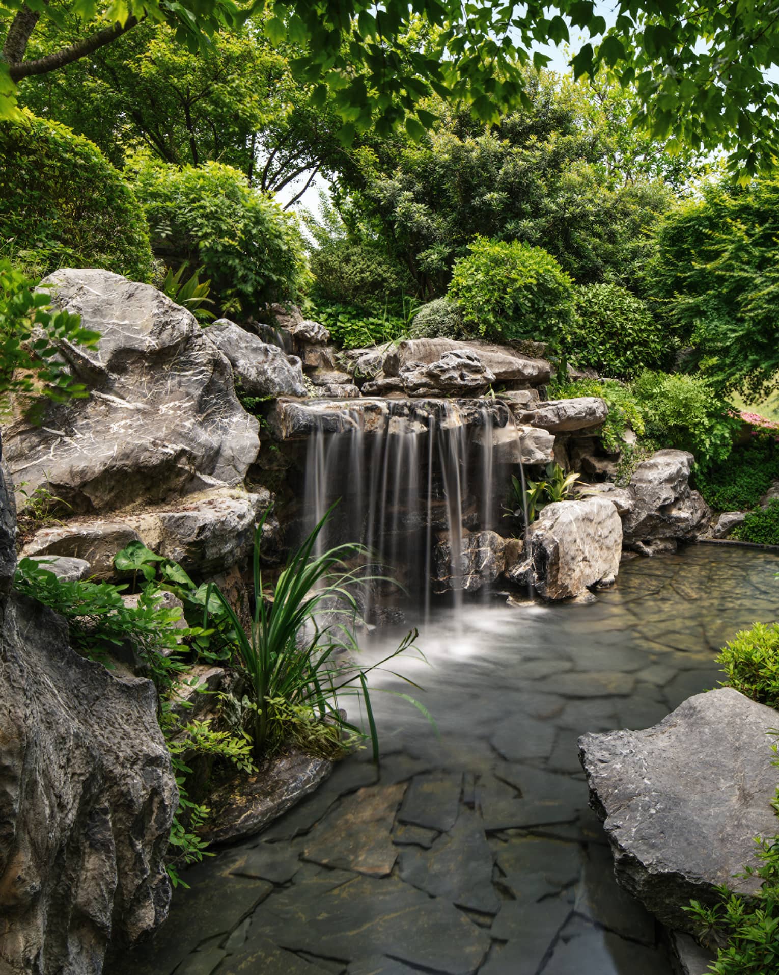 Gardens with waterfall feature at luxury hotel