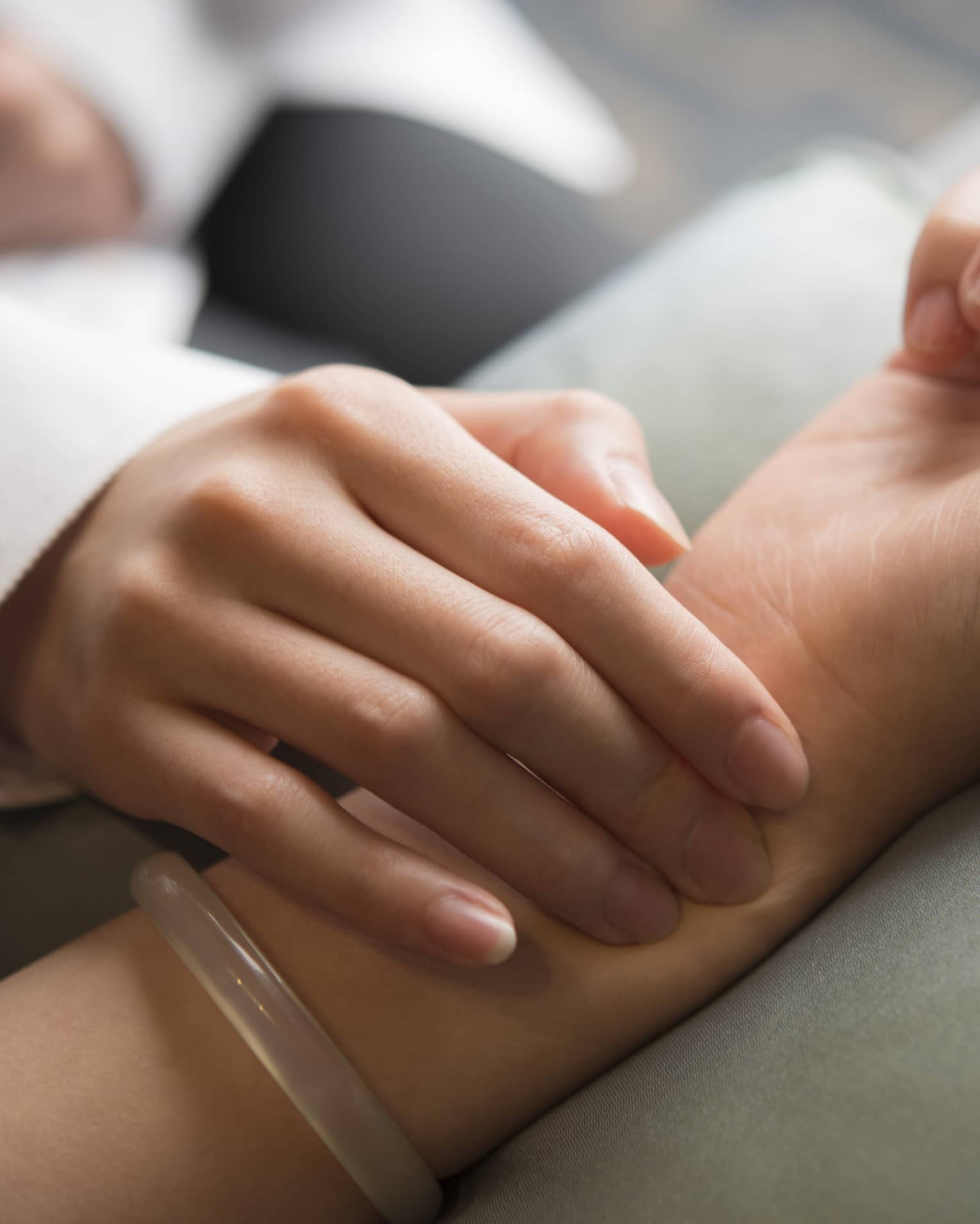 Hand placed on wrist in spa