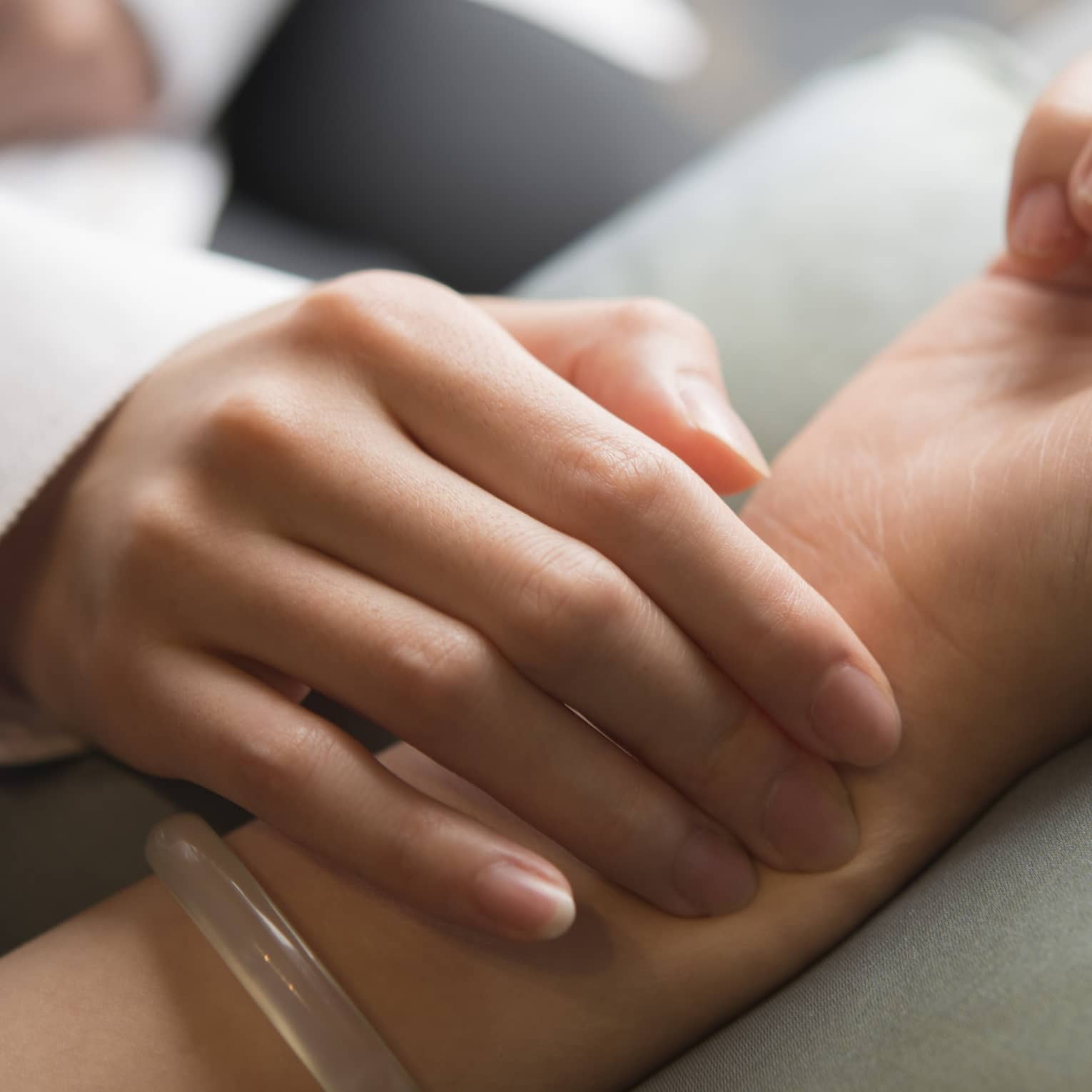 Hand placed on wrist in spa