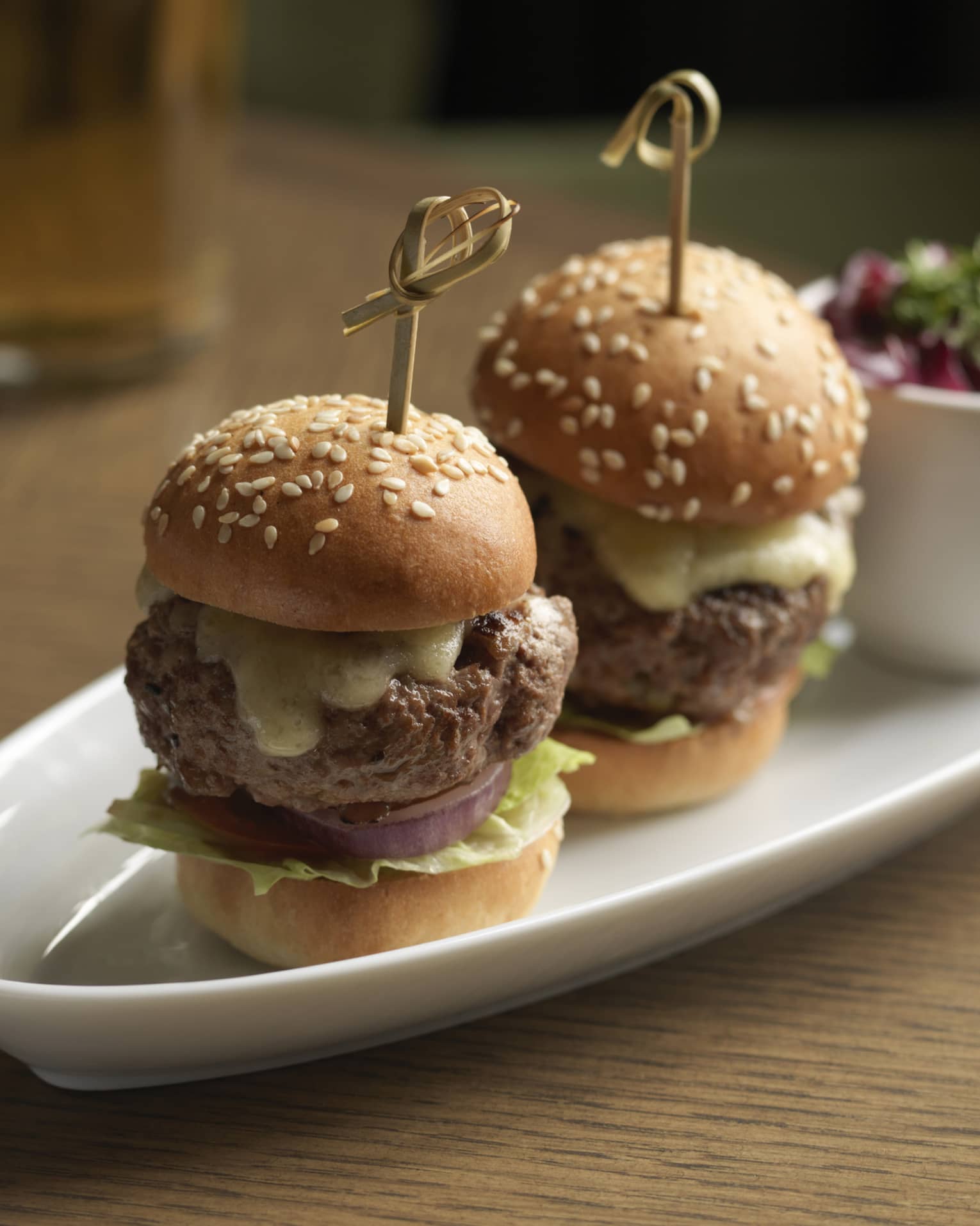 Two Kobe beef sliders served with kimchi slaw and smoked Gouda