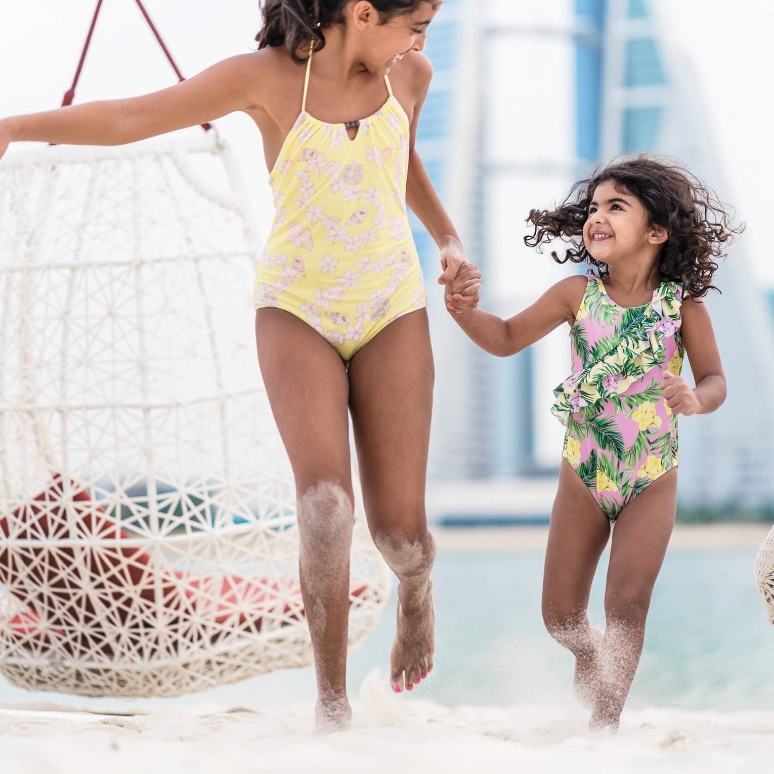 Children running on sandy beach at a luxury resort