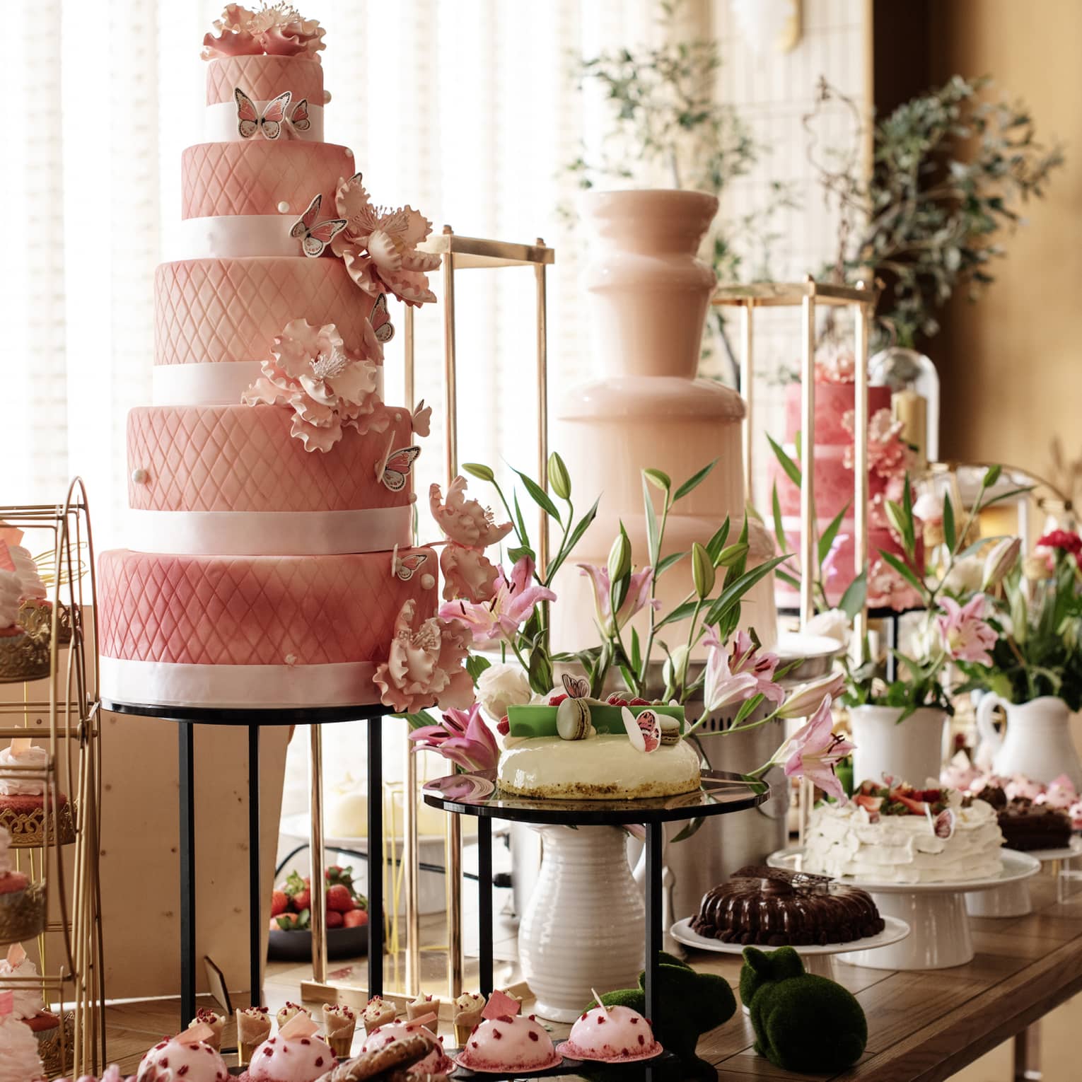 A buffet with cakes, cupcakes and desserts