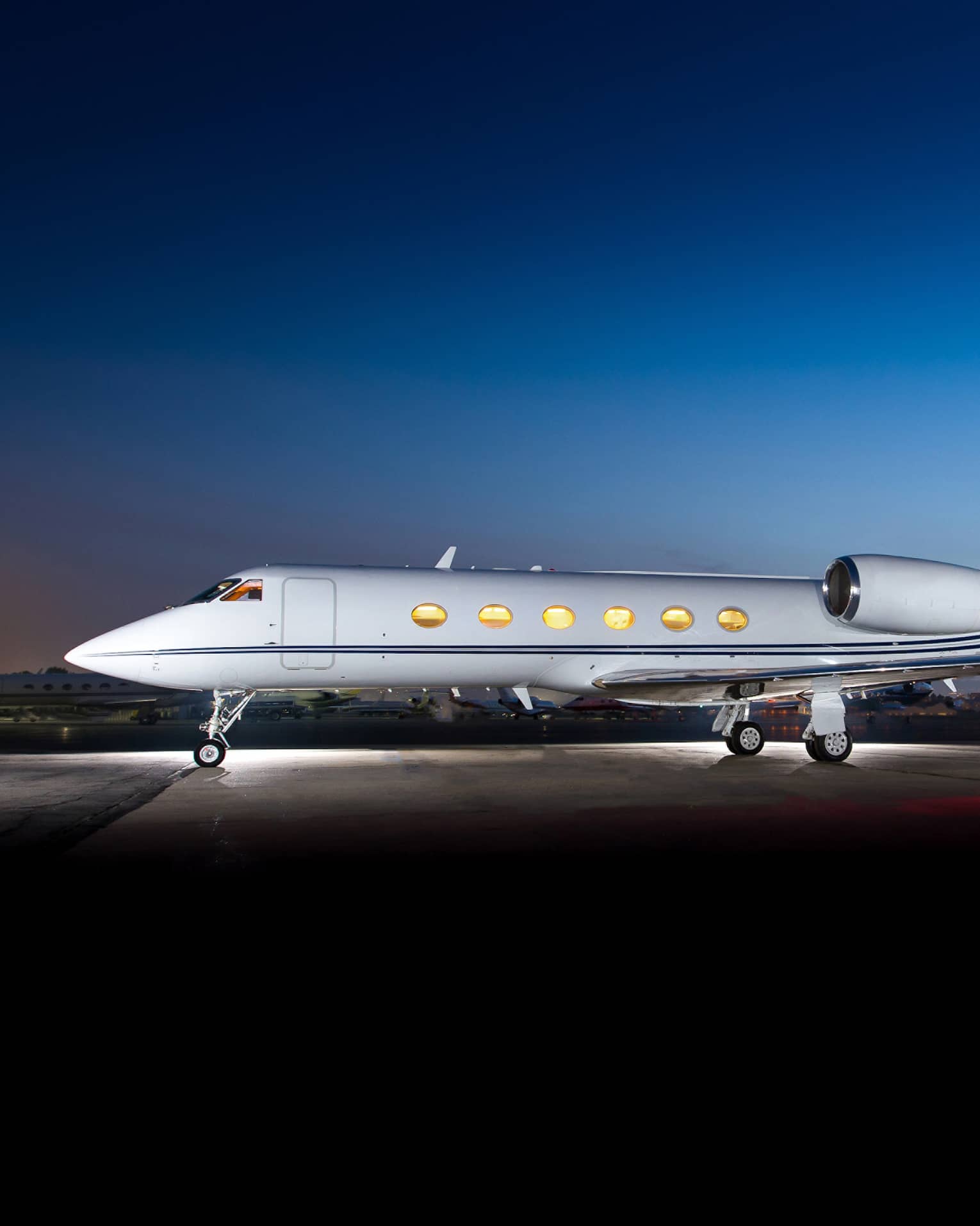Jet Edge private jet on airport runway at dusk