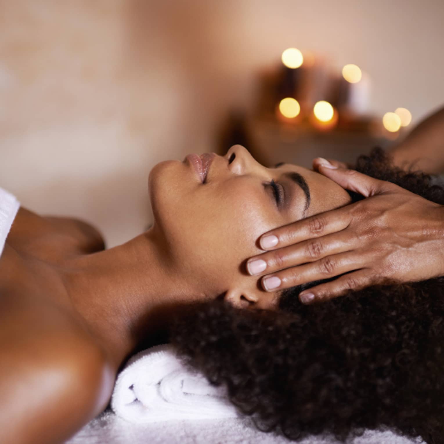 Woman laying down on massage bed getting a massage.