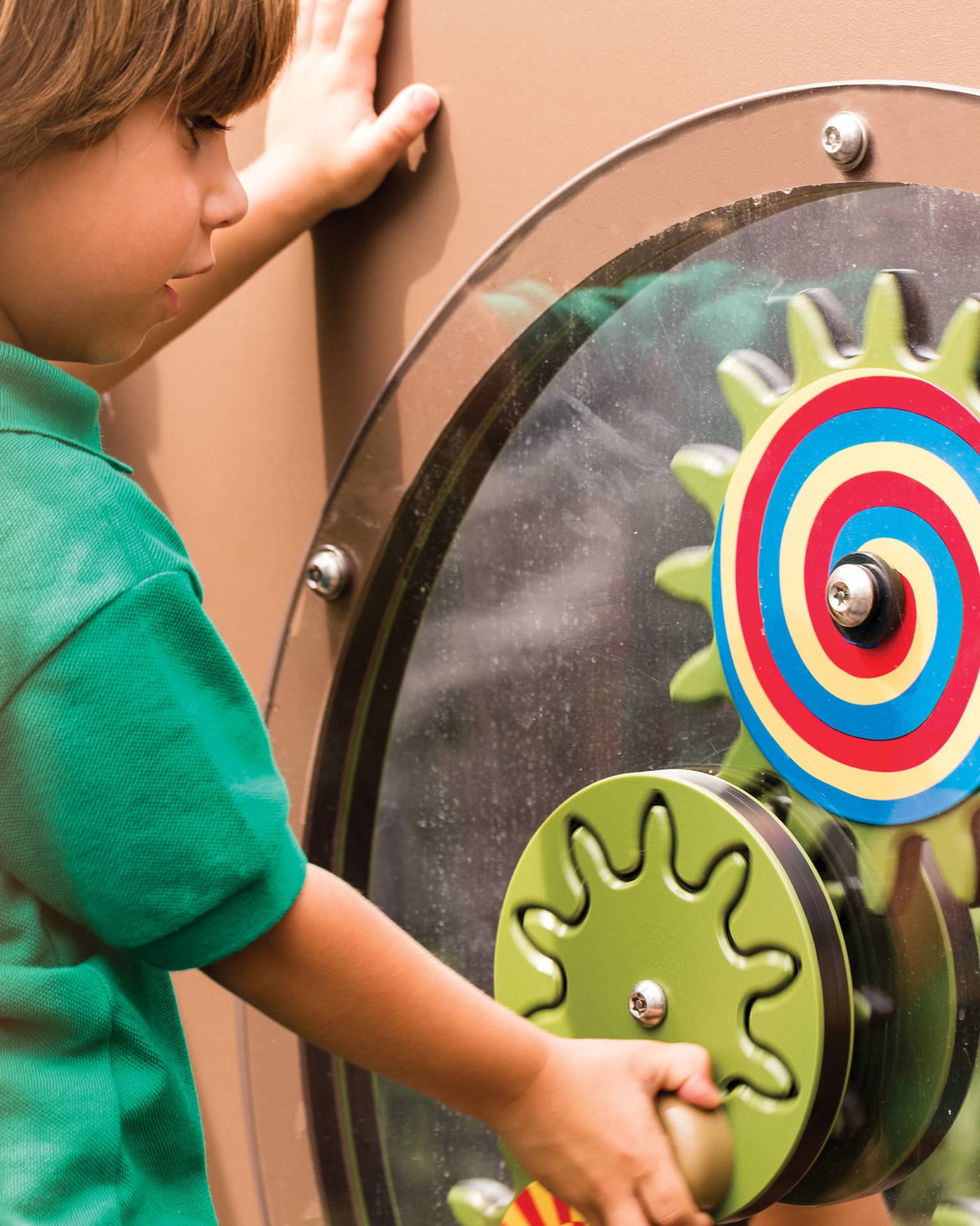 Young boy spins colourful wheel in Discovery Children's Museum