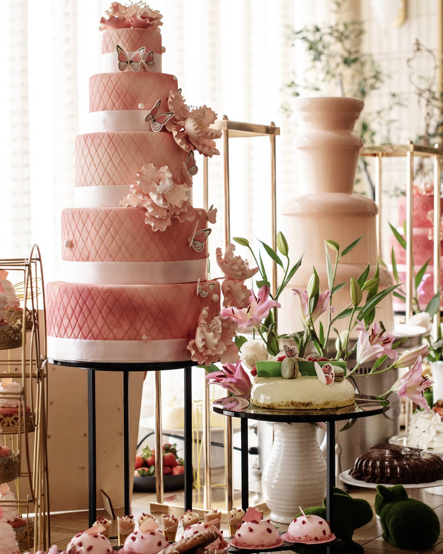 A buffet with cakes, cupcakes and desserts