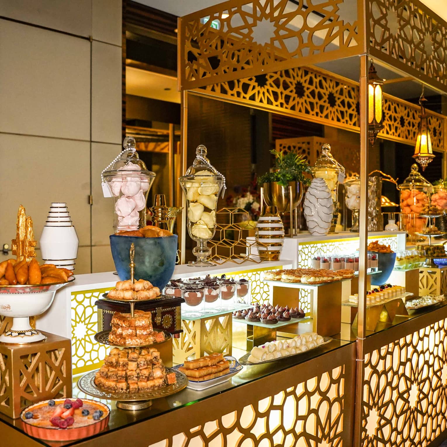 Buffet spread served on a large counter decorated in gold metal filigrees and cut-out patterns