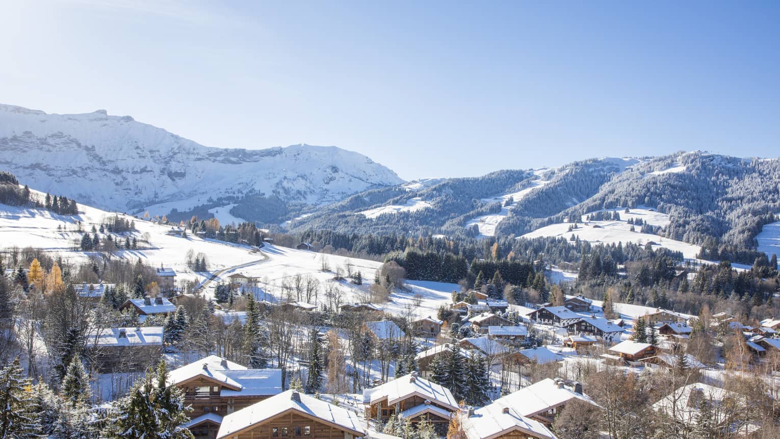 View over Megève Village chalets, snowy rooftops on mountain