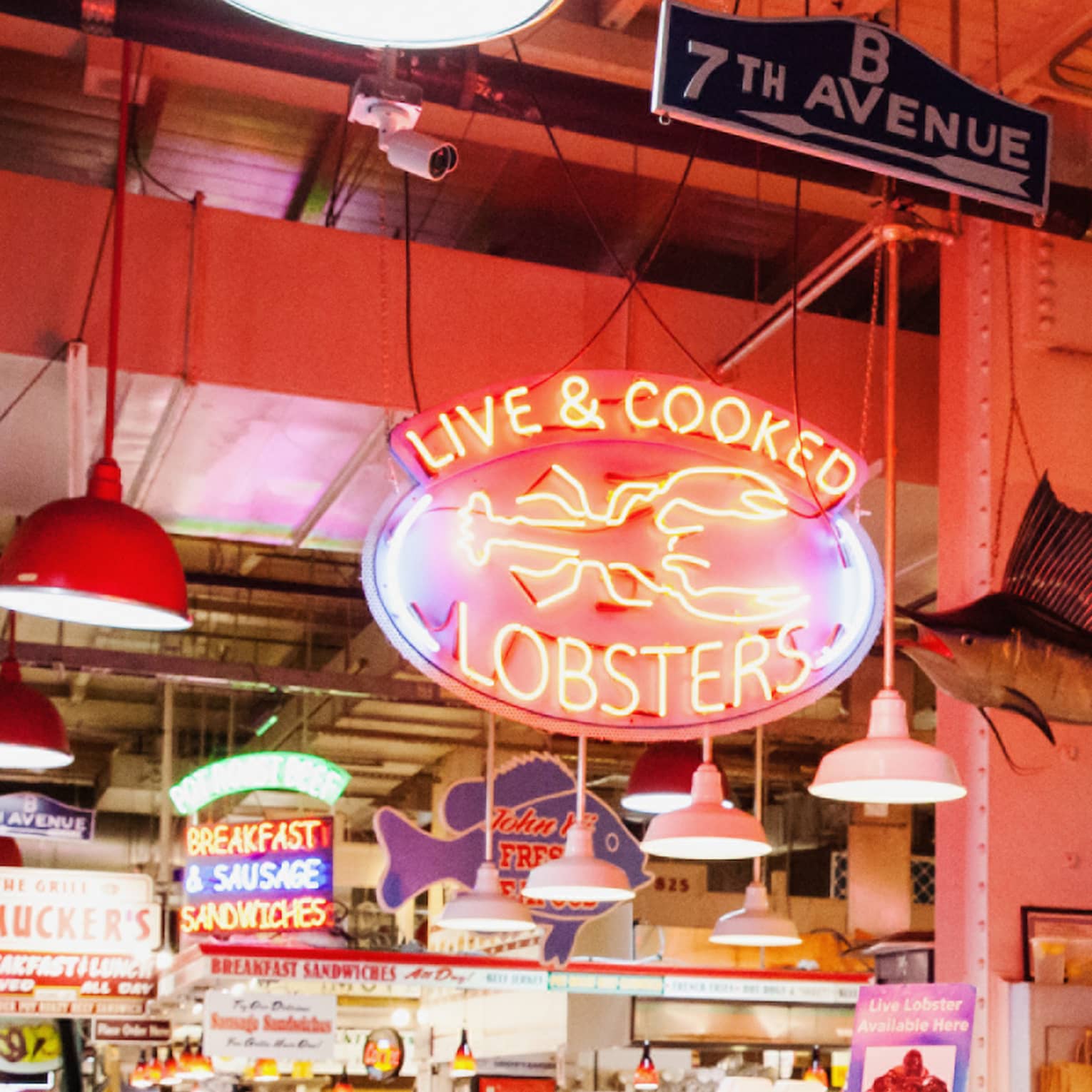 A large indoor market featuring fresh seafood behind glass windows.