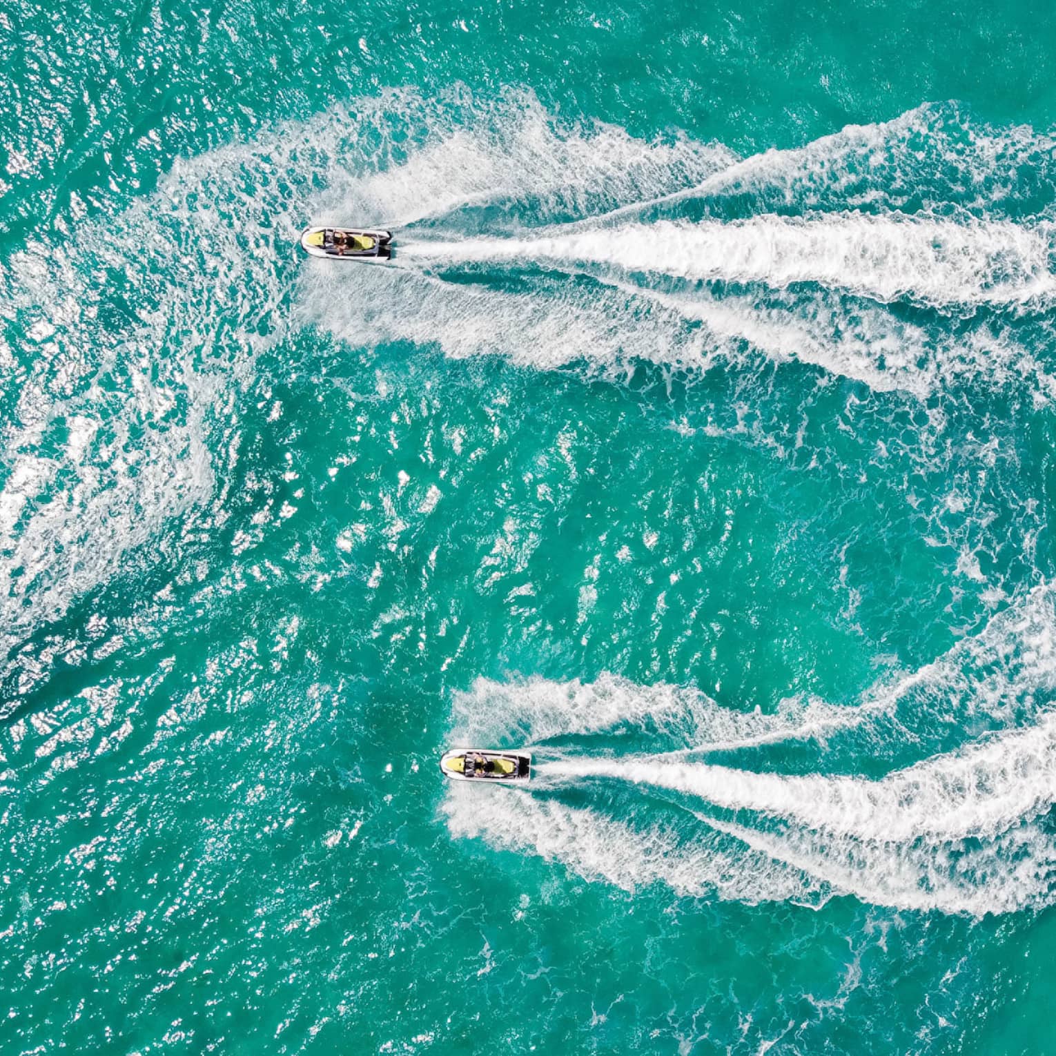 Aerial view of two people on jet skis