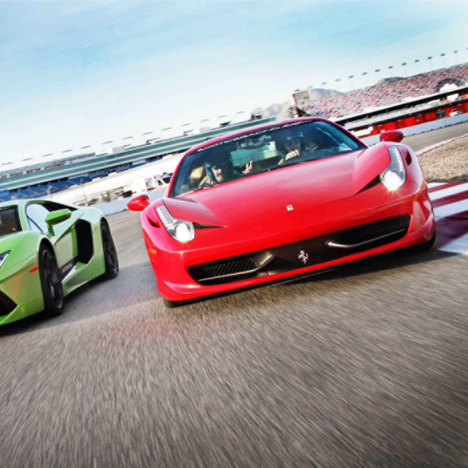 Red and green sports cars on race track