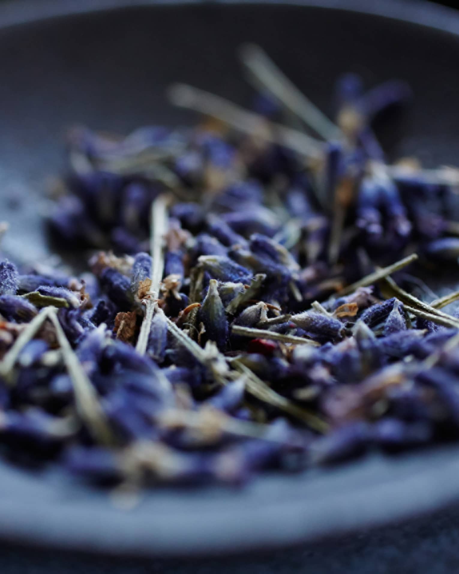 Lavender flowers in a grey bowl.