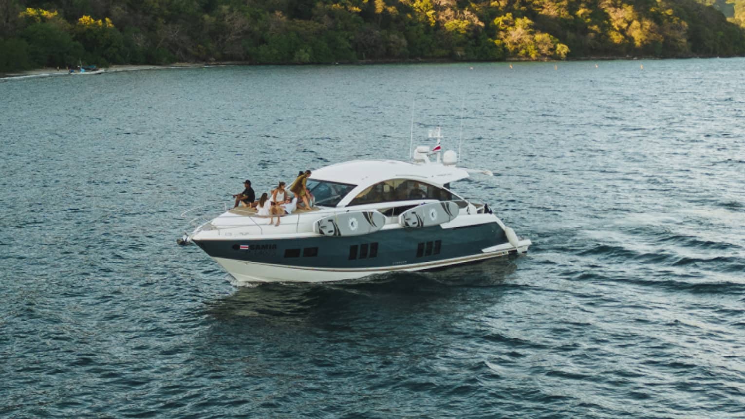 Power boat on water near green hills