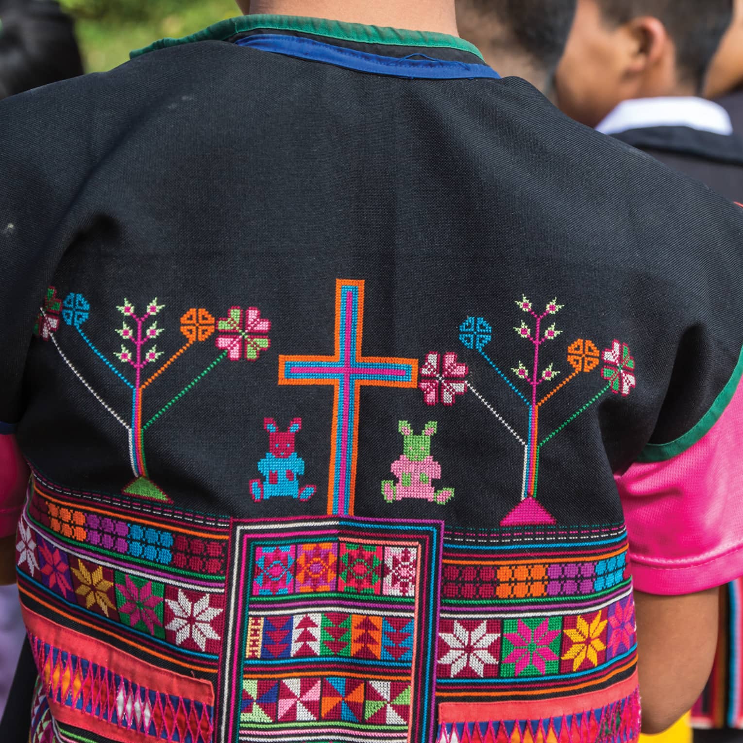 Close-up of colourful textiles on clothing made by hill tribes