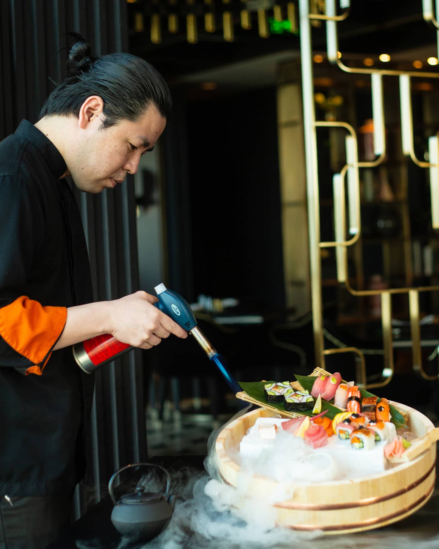 Chef Yonaha uses a torch to put the finishing touches on a signature dish