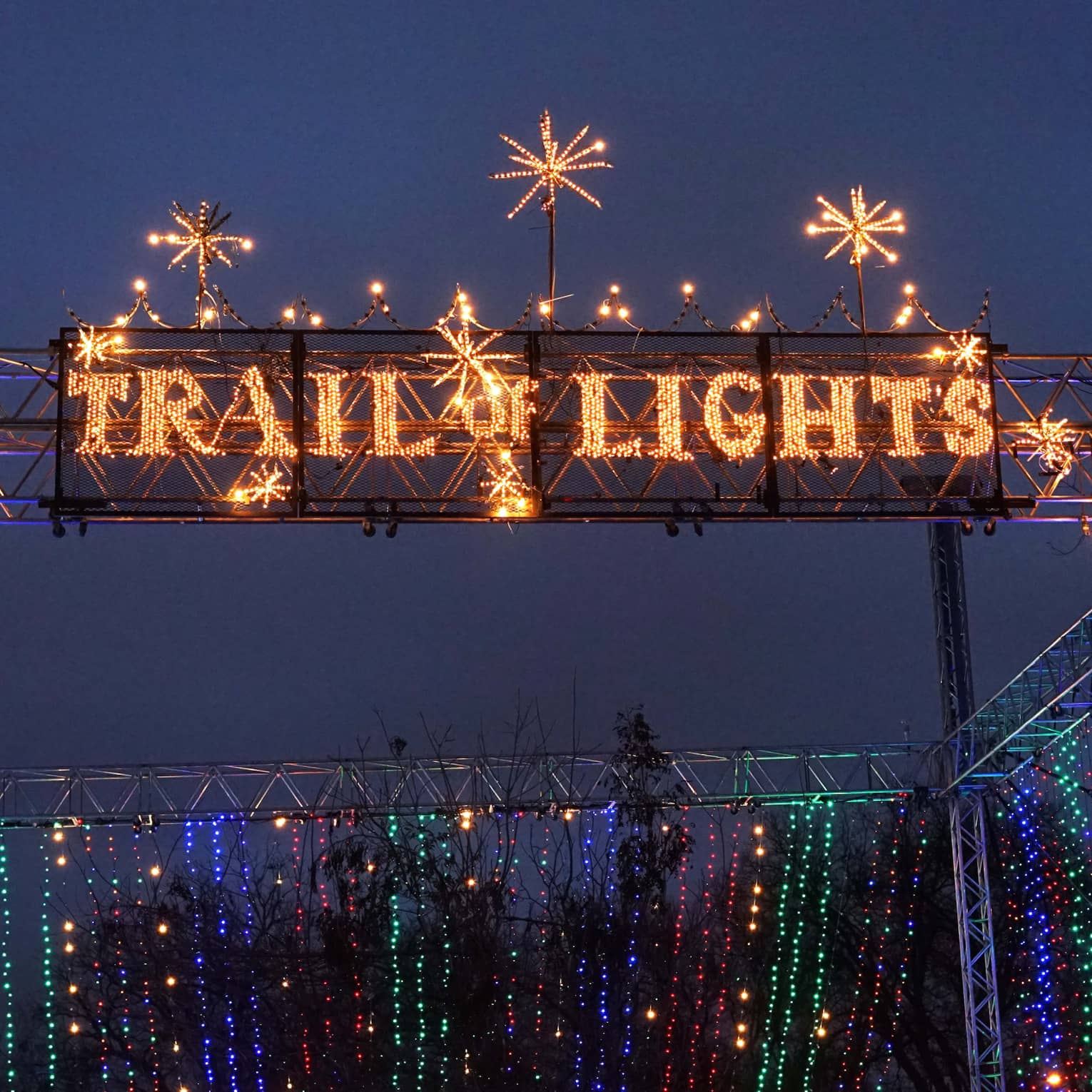 A shining sign that reads "Trail of Lights".