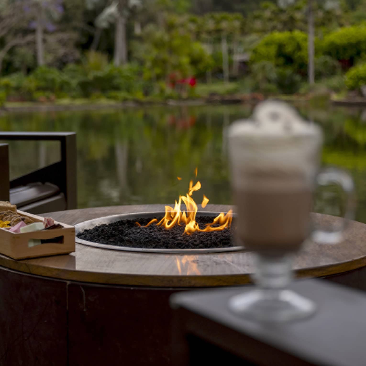 Outdoor, lakeside s'mores and hot chocolate on a deck