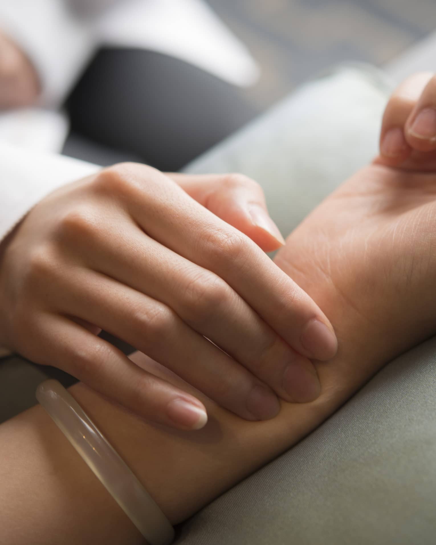 Hand placed on wrist in spa
