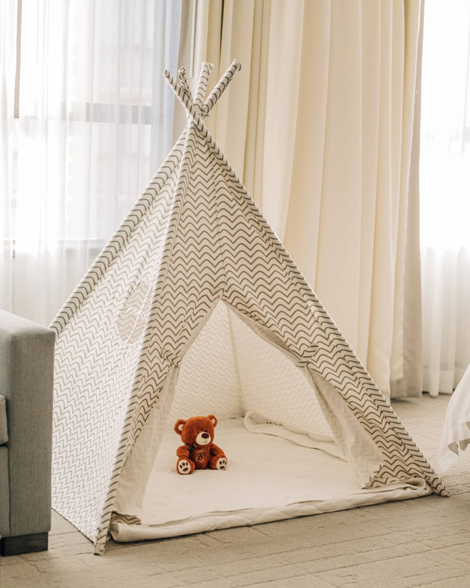 A kids tent with a stuffed animal in a guest room