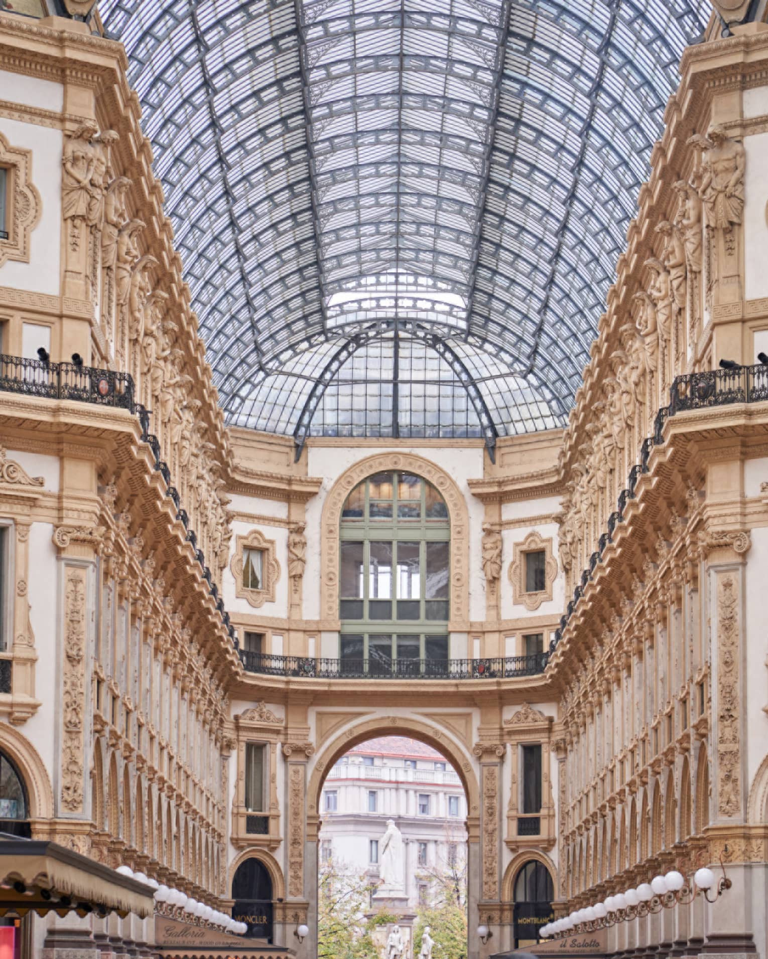 Historic Milan buildings and shops under glass vaulted ceiling