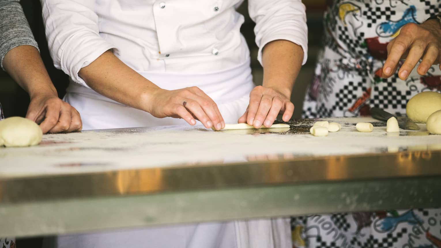 A chef demonstrates shaping pasta dough