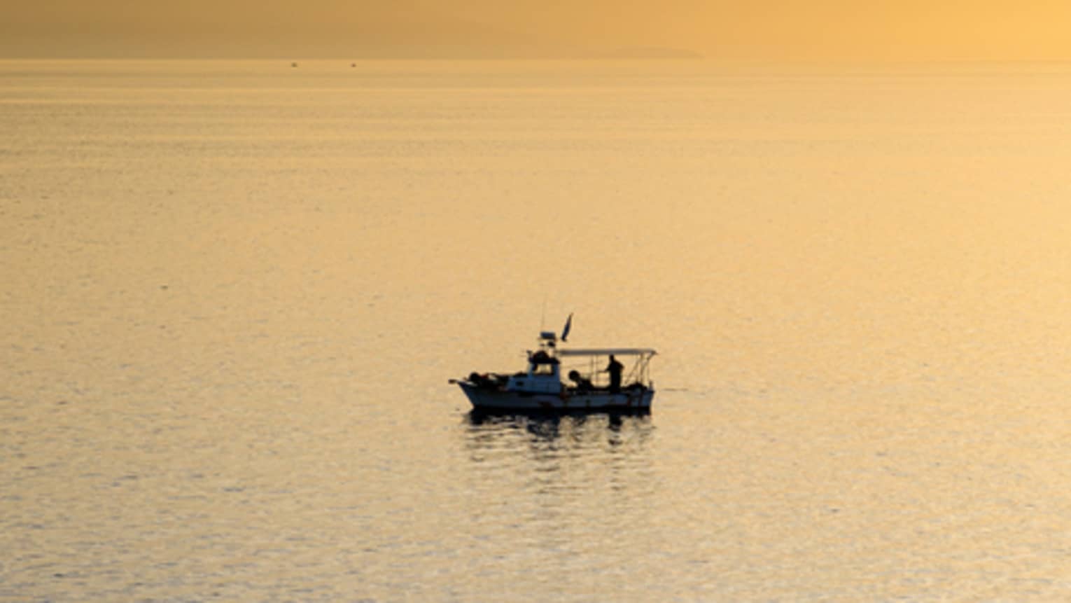 A boat on water at sunset