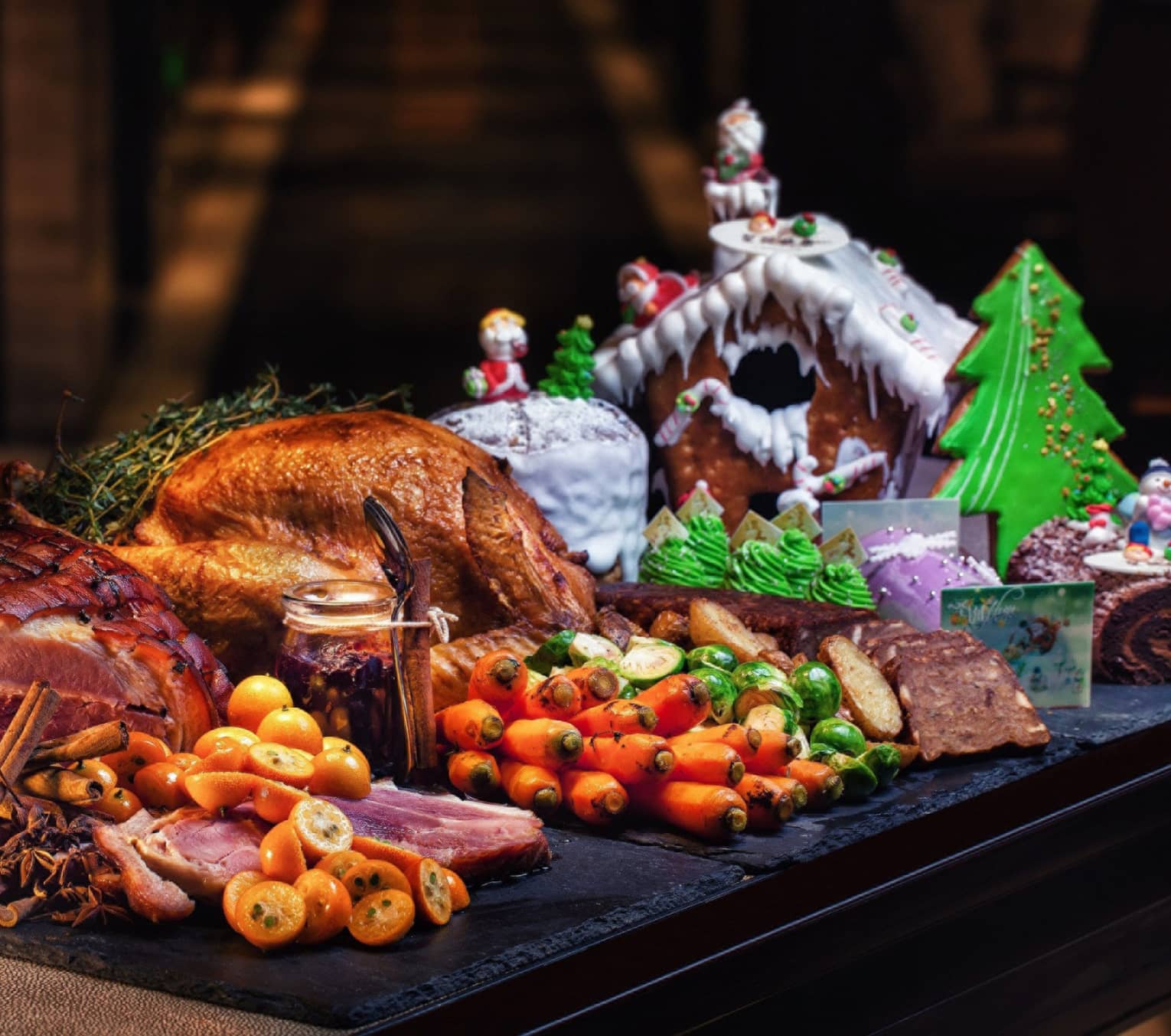 Christmas dinner with turkey and vegetables with gingerbread house on the side