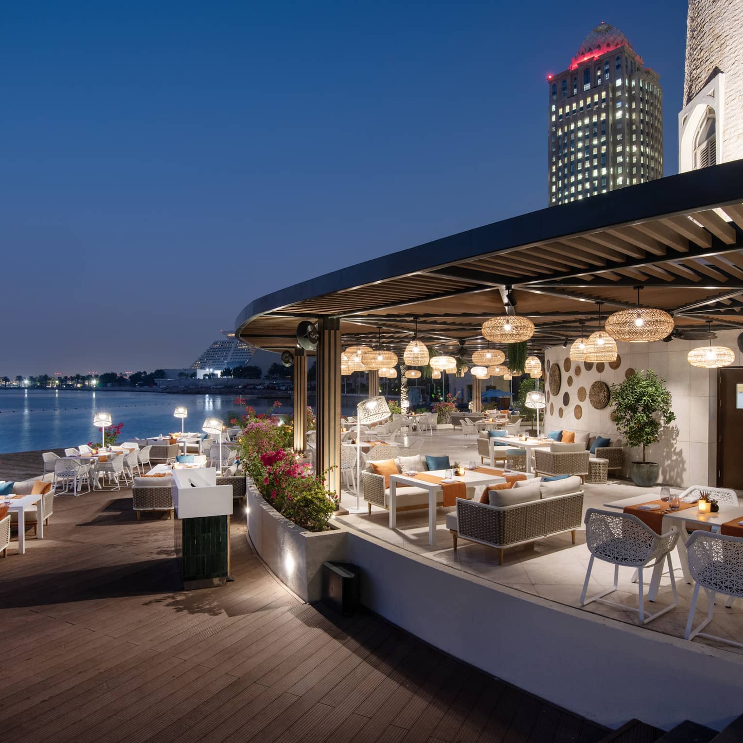 Makani Beach Club terrace overlooking the water at dusk