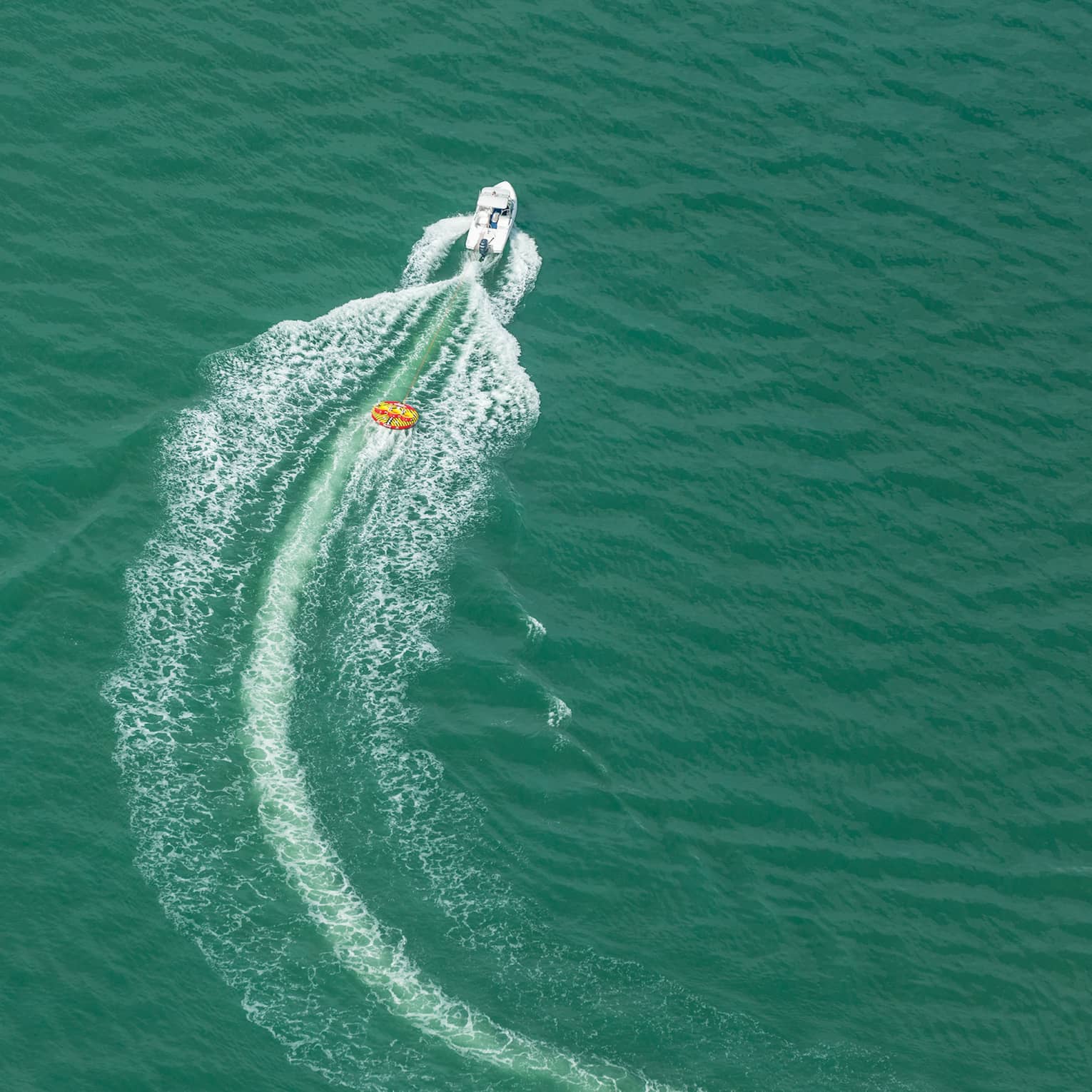 Aerial view of a boat moving through the ocean.