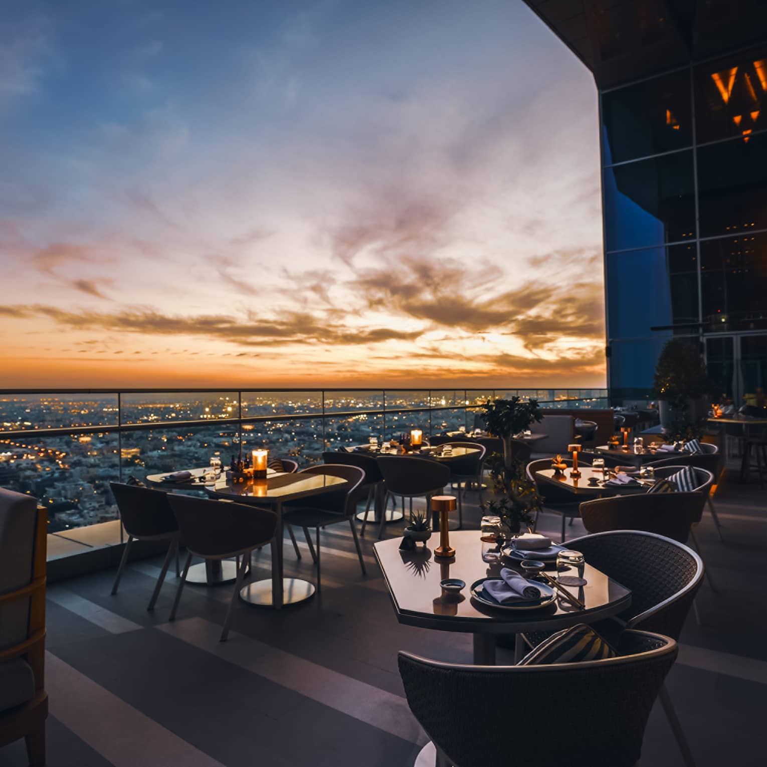 Restaurant terrace overlooking a city skyline at dusk