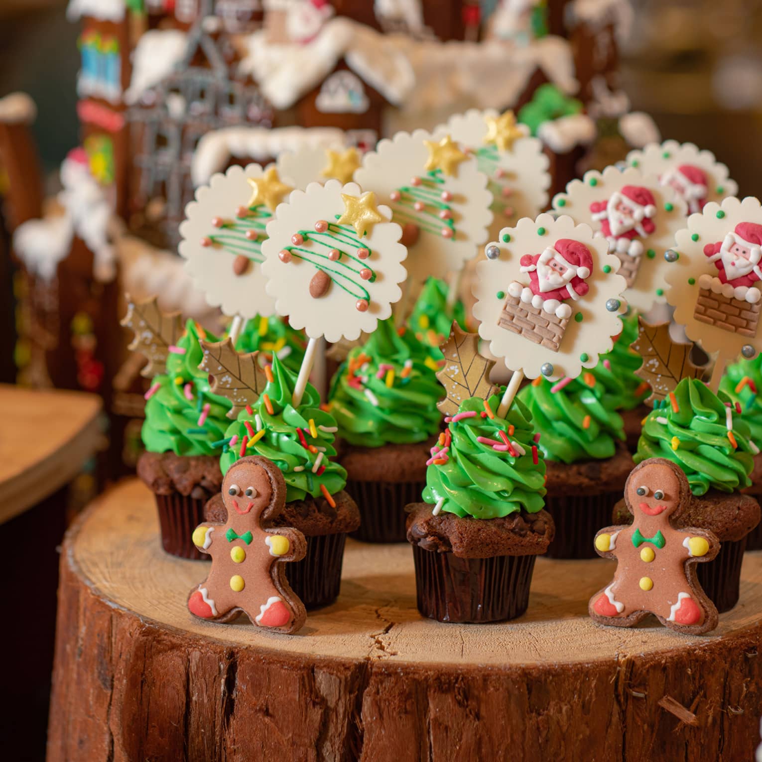 Various Christmas confections lined up on a log