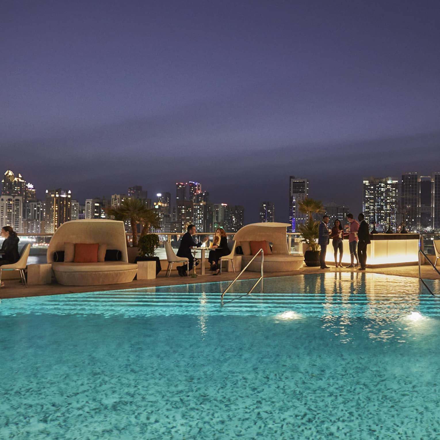 People gather around Eclipse pool at night