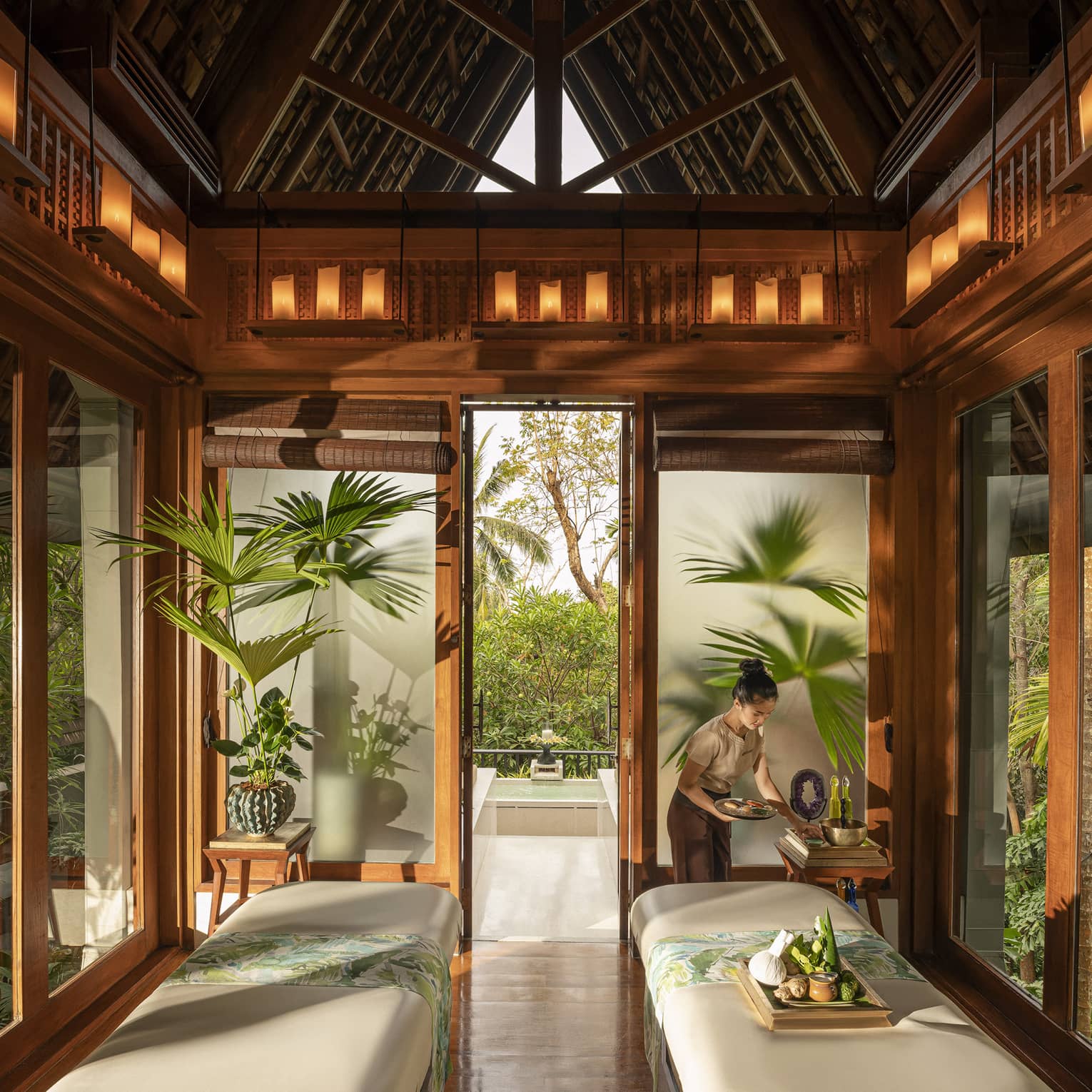 Spa team member prepares couples treatment room