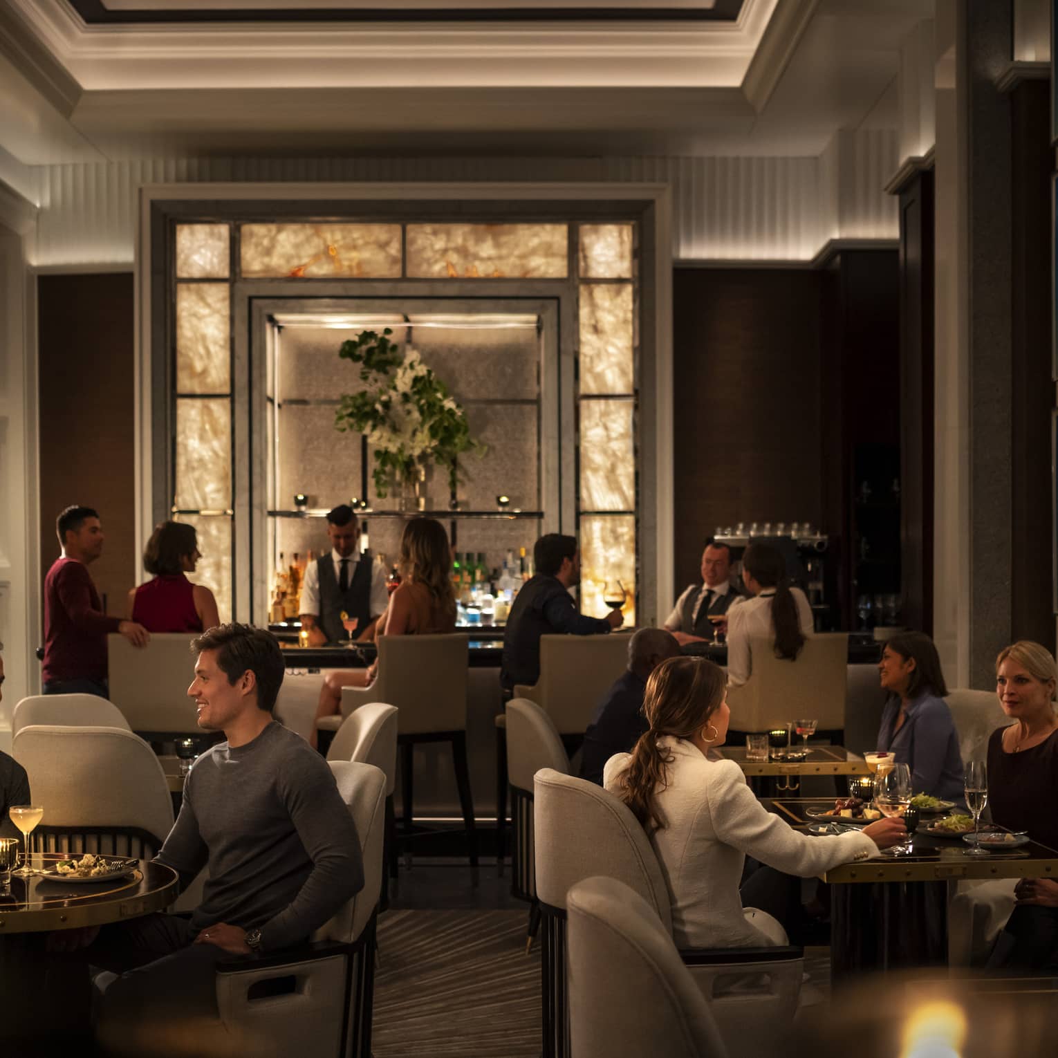 A group of people dining at a dimly lit restaurant.