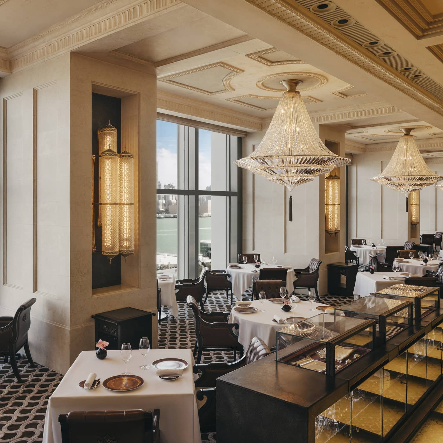 Elegant harbour-view restaurant featuring an intricate ceiling lined with crystal chandeliers