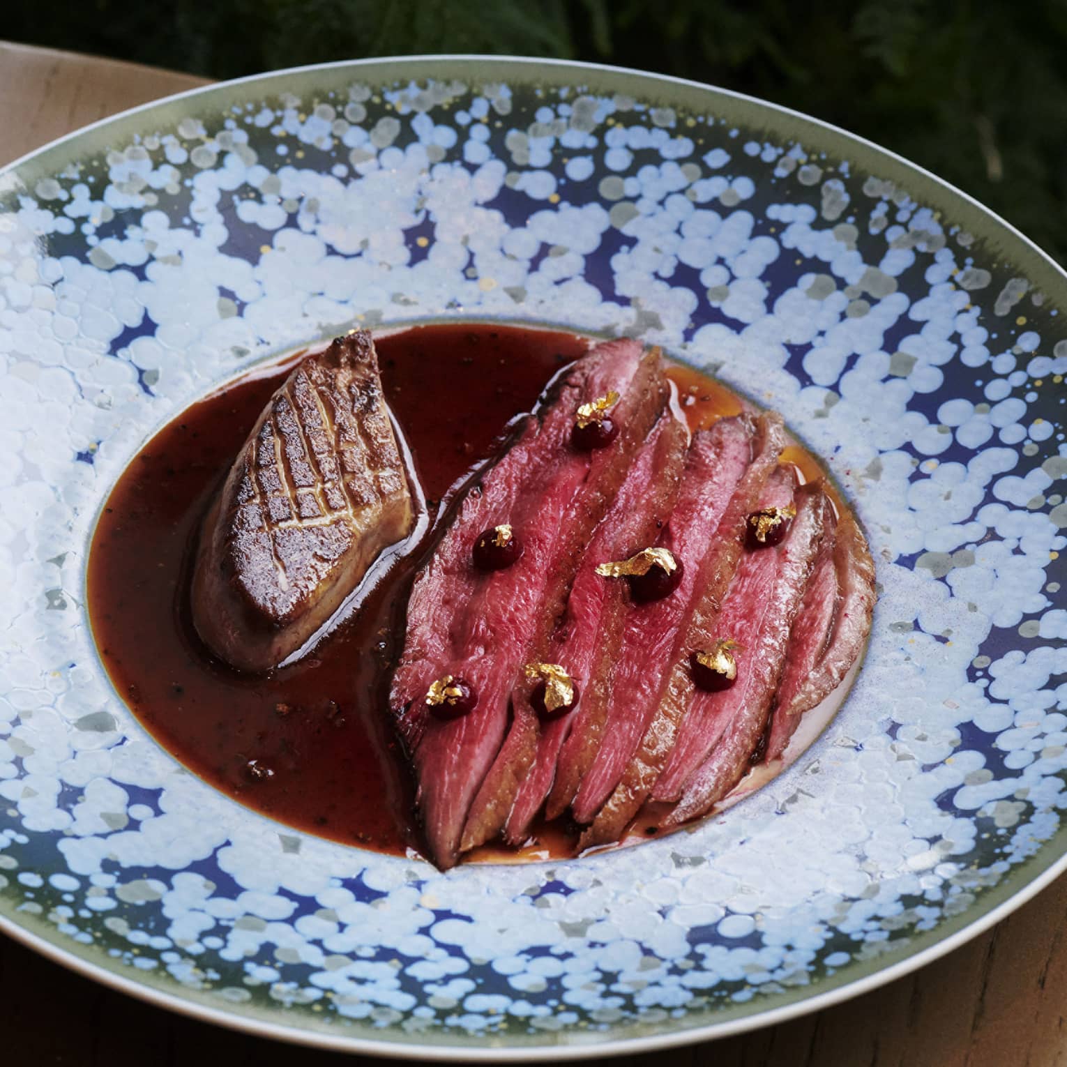 Sliced steak in a brown sauce.