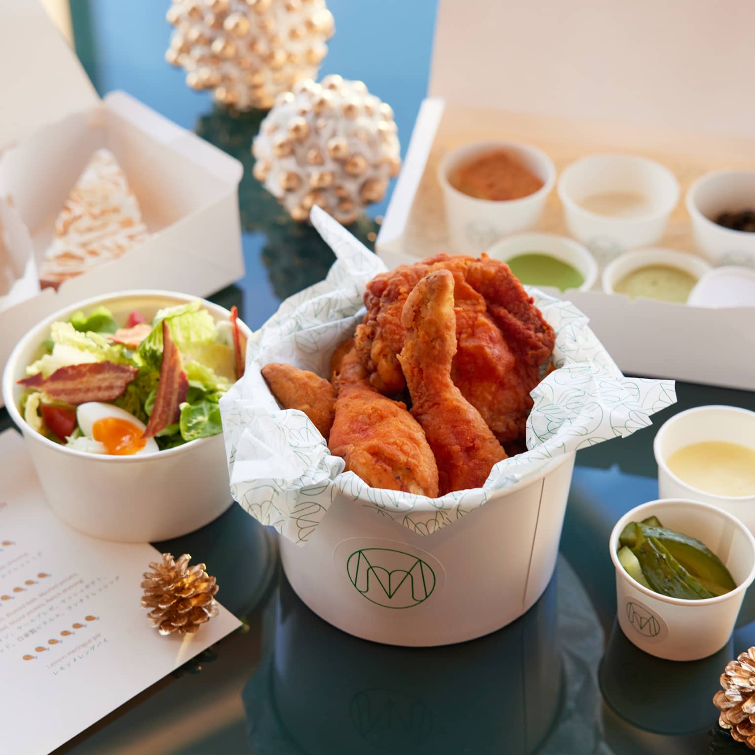 Fried chicken takeaway package with Cobb salad, braised kale, mashed potatoes, cornbread, house-made pickles, ranch dressing and lemon meringue pie