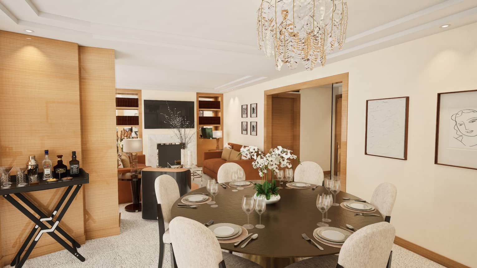 Hotel suite dining room with round dark wood table and six upholstered white chairs under chandelier